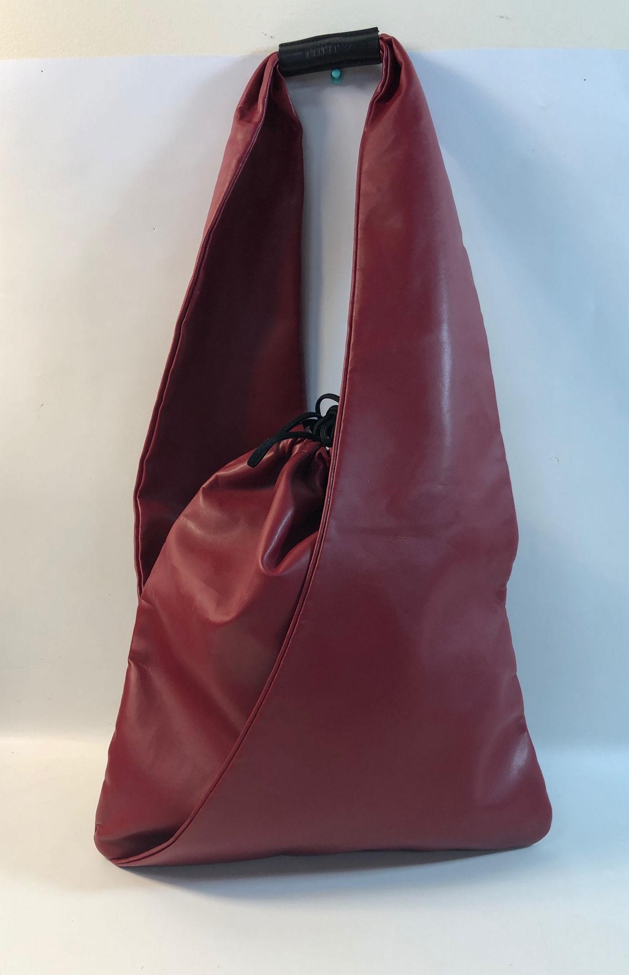 MAISON MARGIELA SHOULDER BAG: MAISON MARGIELA SHOULDER BAG ~ LIKE NEW CONDITION, JAPANESE STYLE BAG, RED LEATHER W/ ORIGINAL SWATCH INSIDE, DRAWSTRING CLOSURE, BLACK INTERIOR, ITALIAN MADE