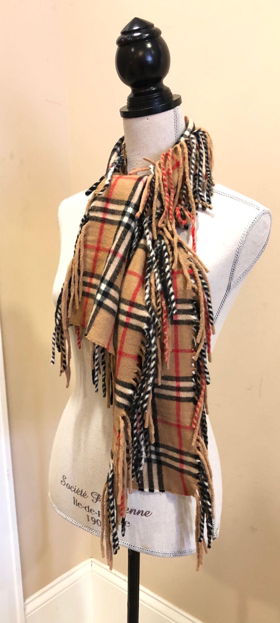 BURBERRY SCARF: BURBERRY SCARF ~ DESIGN FEATURES SIGNATURE PATTERN WITH TASSLED EDGES, GENTLY USED, MADE IN ENGLAND, 100% CASHMERE APPROX. 18" X 52"