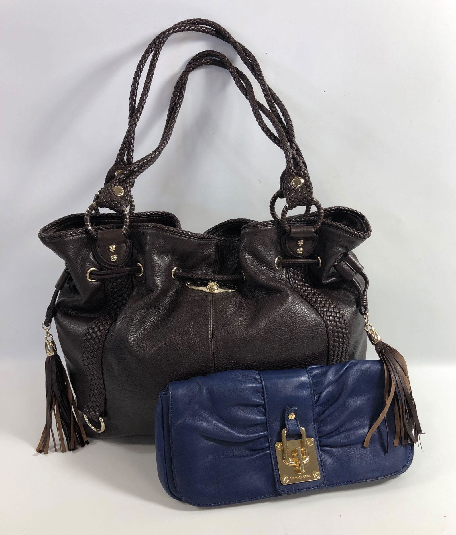 TWO DESIGNER BAGS: TWO DESIGNER BAGS ~ LOT INCLUDES ONE 11.5" X 5.5" BLUE LEATHER CLUTCH FROM MICHAEL KORS WITH GOLD TONE HARDWARE, FOLDVOVER MAGNETIC CLOSURE AND TAN INTERIOR, VERY GOOD CONDITION WITH ORIGINAL CARE TAG