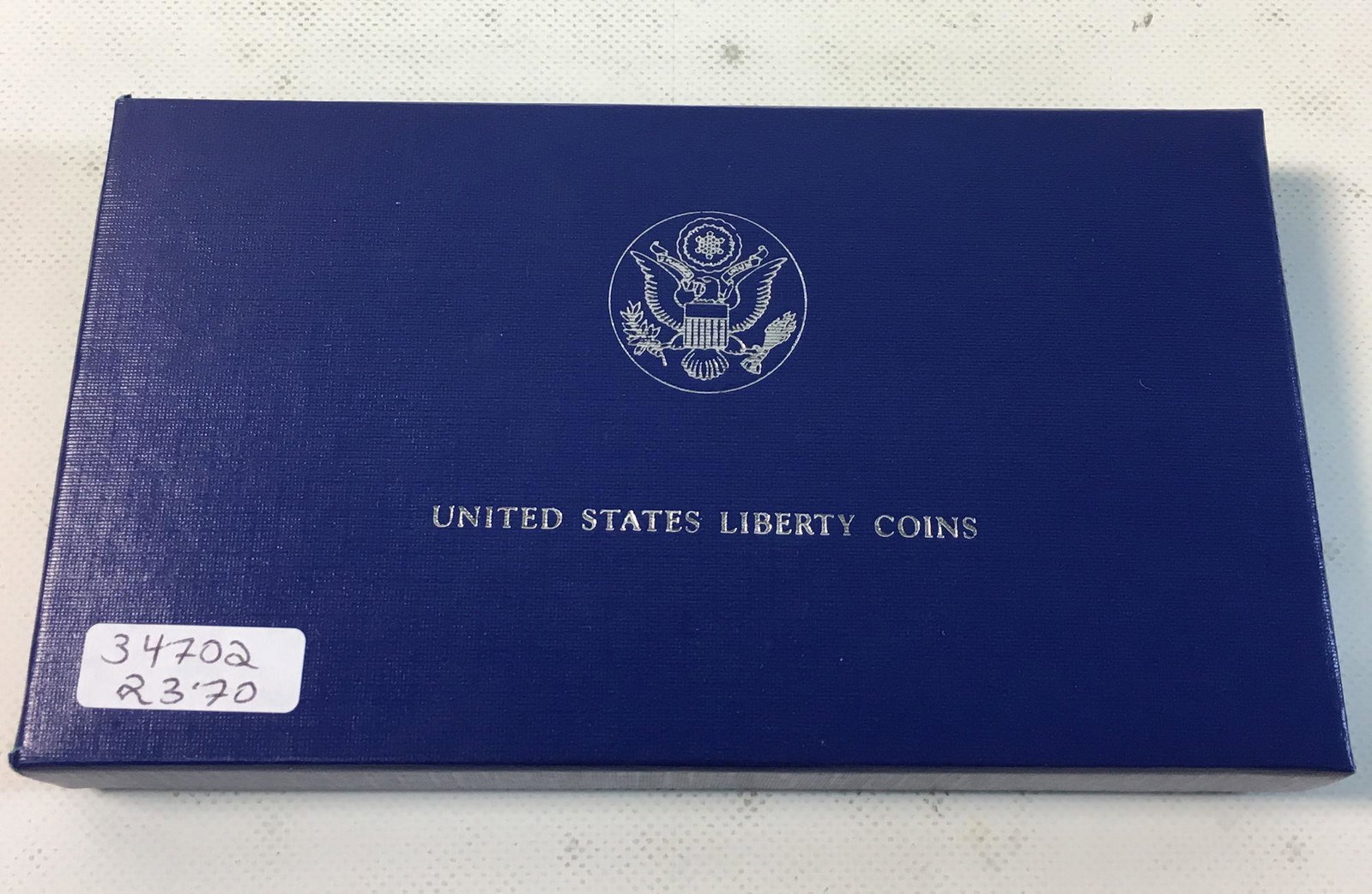 UNITED STATES LIBERTY COINS: UNITED STATES LIBERTY COINS ~ SILVER ELLIS ISLAND AND STATUE OF LIBERTY DOLLAR AND HALF DOLLAR COINS IN BOX. UNCIRCULATED.