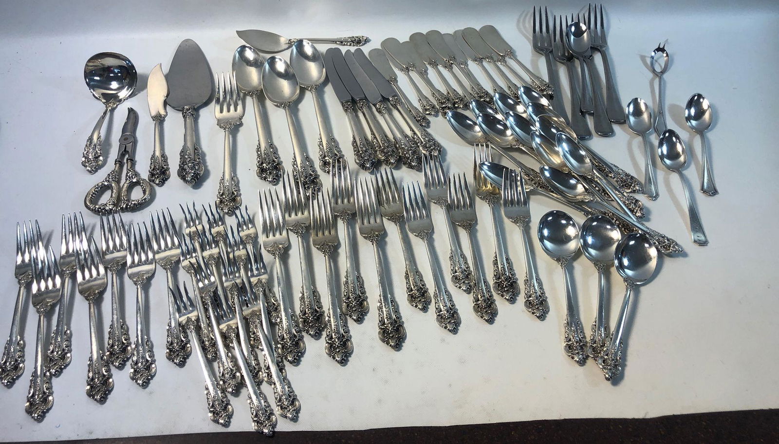 STERLING FLATWARE AND SERVEWARE LOT: STERLING FLATWARE AND SERVEWARE LOT ~ MOST PIECES FROM THE WALLACE 1941 "GRAND BAROQUE" PATTERN (INCOMPLETE SET) INCLUDING: THREE SOUP SPOONS, TWELVE TABLESPOONS, TWELVE COCKTAIL FORKS, TWELVE SALAD F
