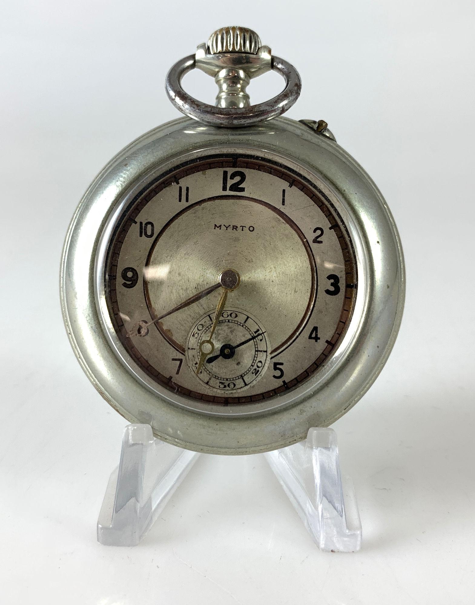 MYRTO POCKET WATCH: MYRTO POCKET WATCH ~ 1.875" DIAMETER CASE (SILVER TONE). MOVEMENT STAMPED "DIOGENES" AND "REGISTERED" W/A LAMP SHAPED HALLMARK. POSSIBLY FRENCH MOVEMENT FT. SPEED ADJUSTMENT LABELED "RETARD" AND "AVAN