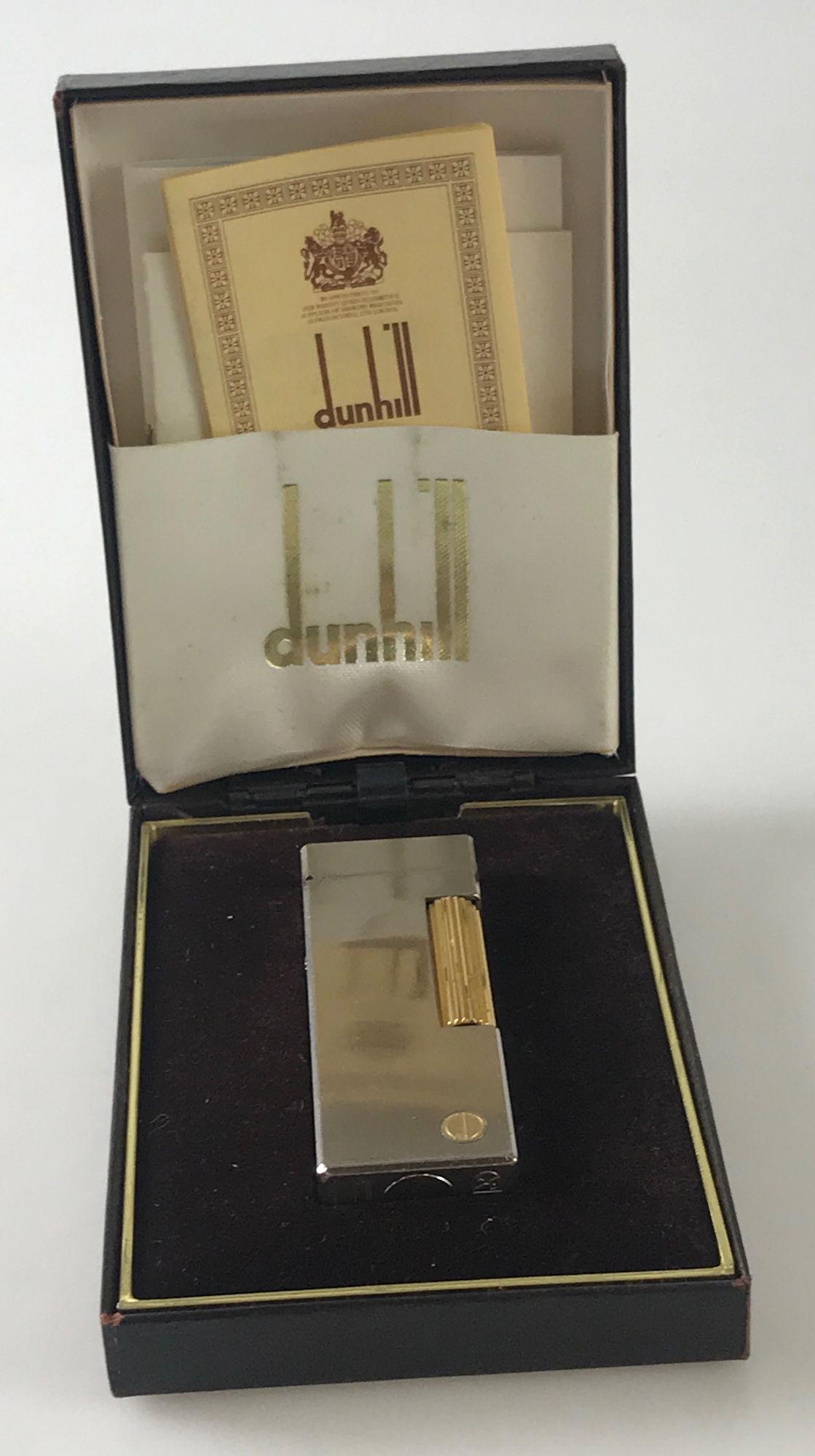 VINTAGE DUNHILL LIGHTER: VINTAGE DUNHILL LIGHTER ~ NOS IN ORIGINAL BOX WITH CARE CARD AND SERVICE INSTRUCTIONS, RECTANGULAR SHAPE, APPROX. 2.5" H, DUAL TONE METAL, BRUSHED FINISH, SWISS MADE, ETCHED MONOGRAMMED TOP