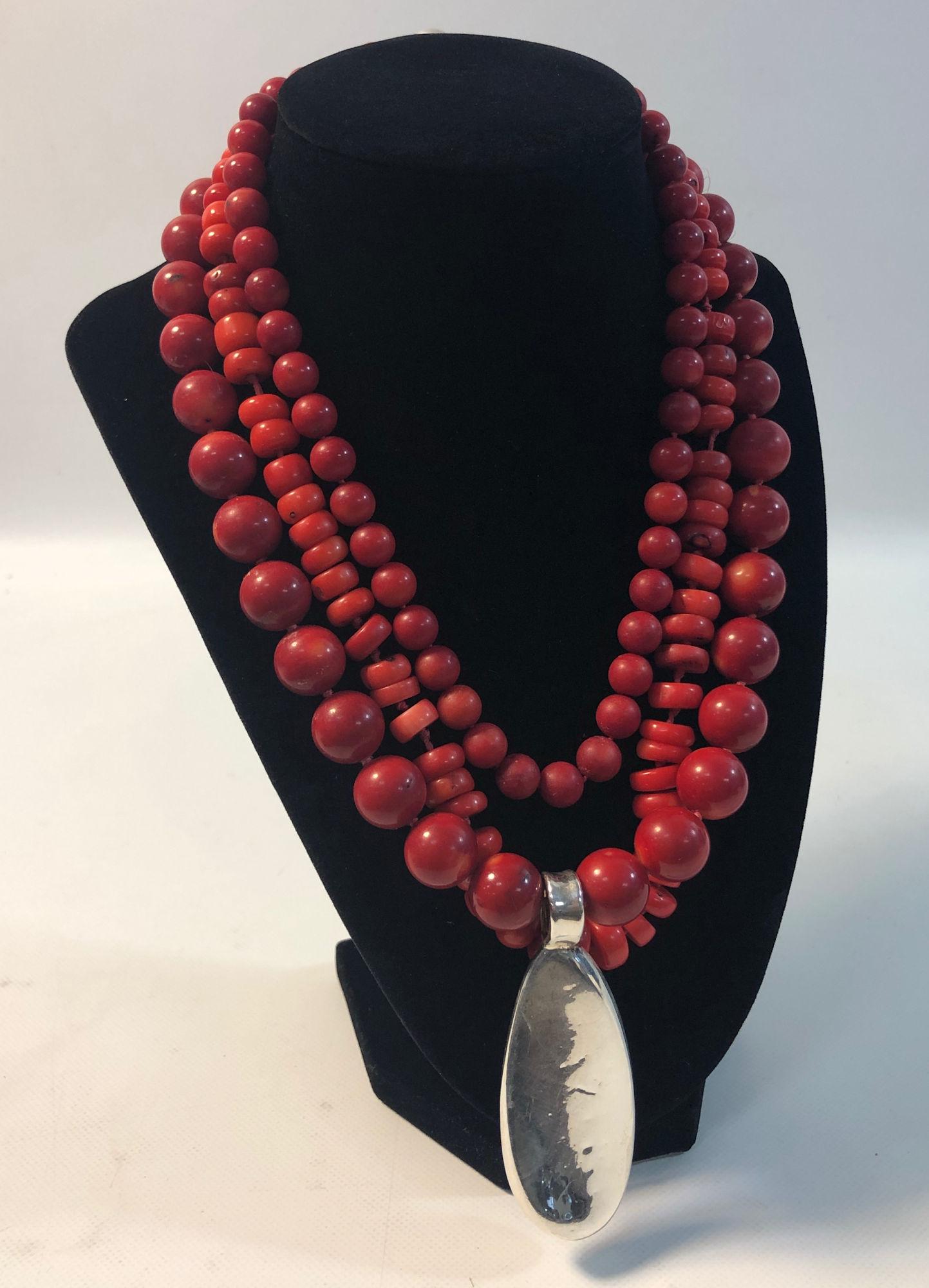 CORAL FASHION NECKLACE: CORAL FASHION NECKLACE ~ 18" PRINCESS LENGTH NECKLACE W/RED BAMBOO CORAL BEADING ON THREE STRANDS. MAGNETIC SLIDE CLASP (STERLING). 3" STERLING SILVER DROP PENDANT WITH HIGH POLISH FINISH (ABOUT 0.5 T