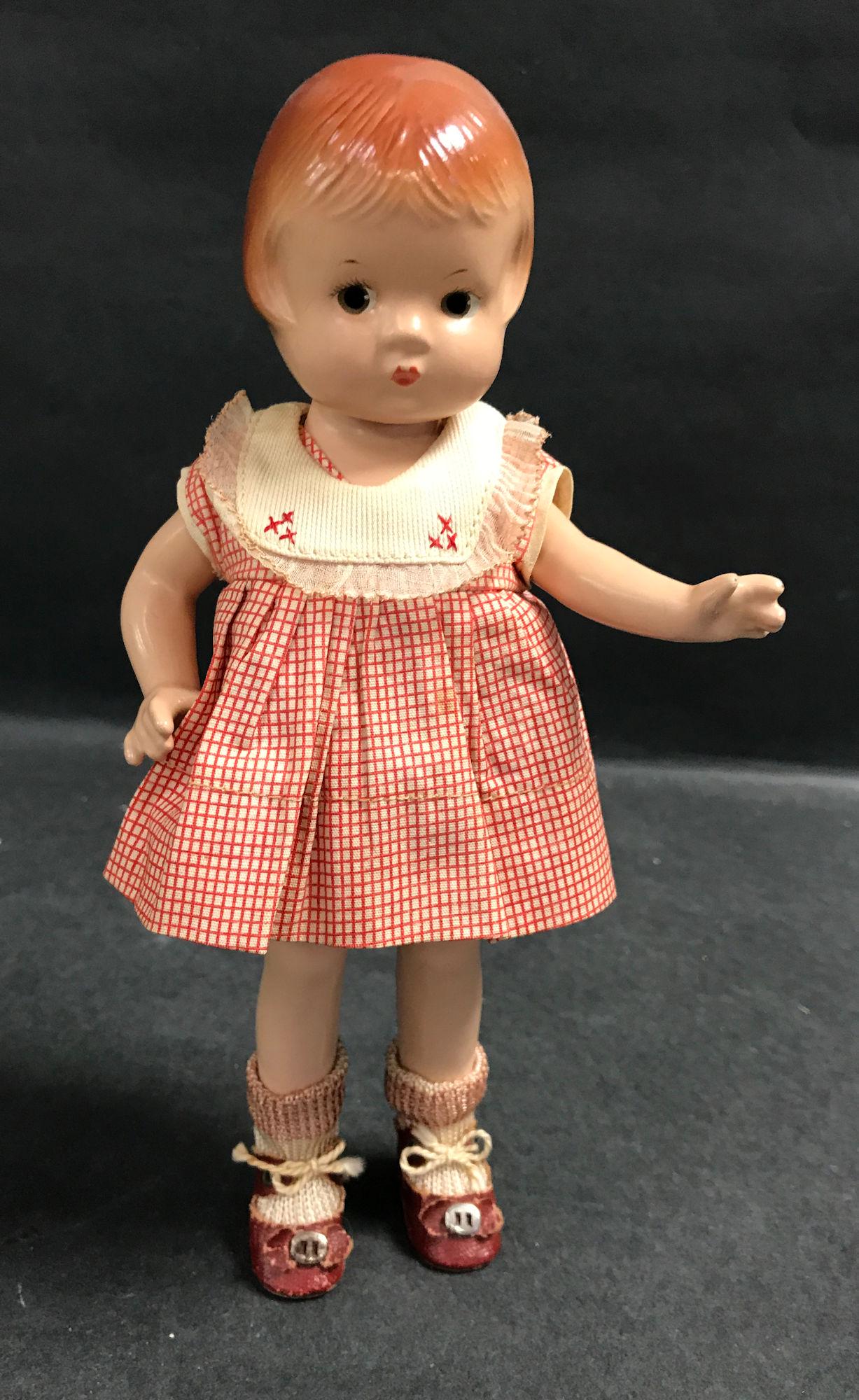 9 ½" VINTAGE ALL COMPOSITION EFFANBEE PATSYETTE: 9 ½" VINTAGE ALL COMPOSITION EFFANBEE PATSYETTE IN TAGGED RED & WHITE CHECKED DRESS AND ORIGINAL SOCKS AND SHOES.