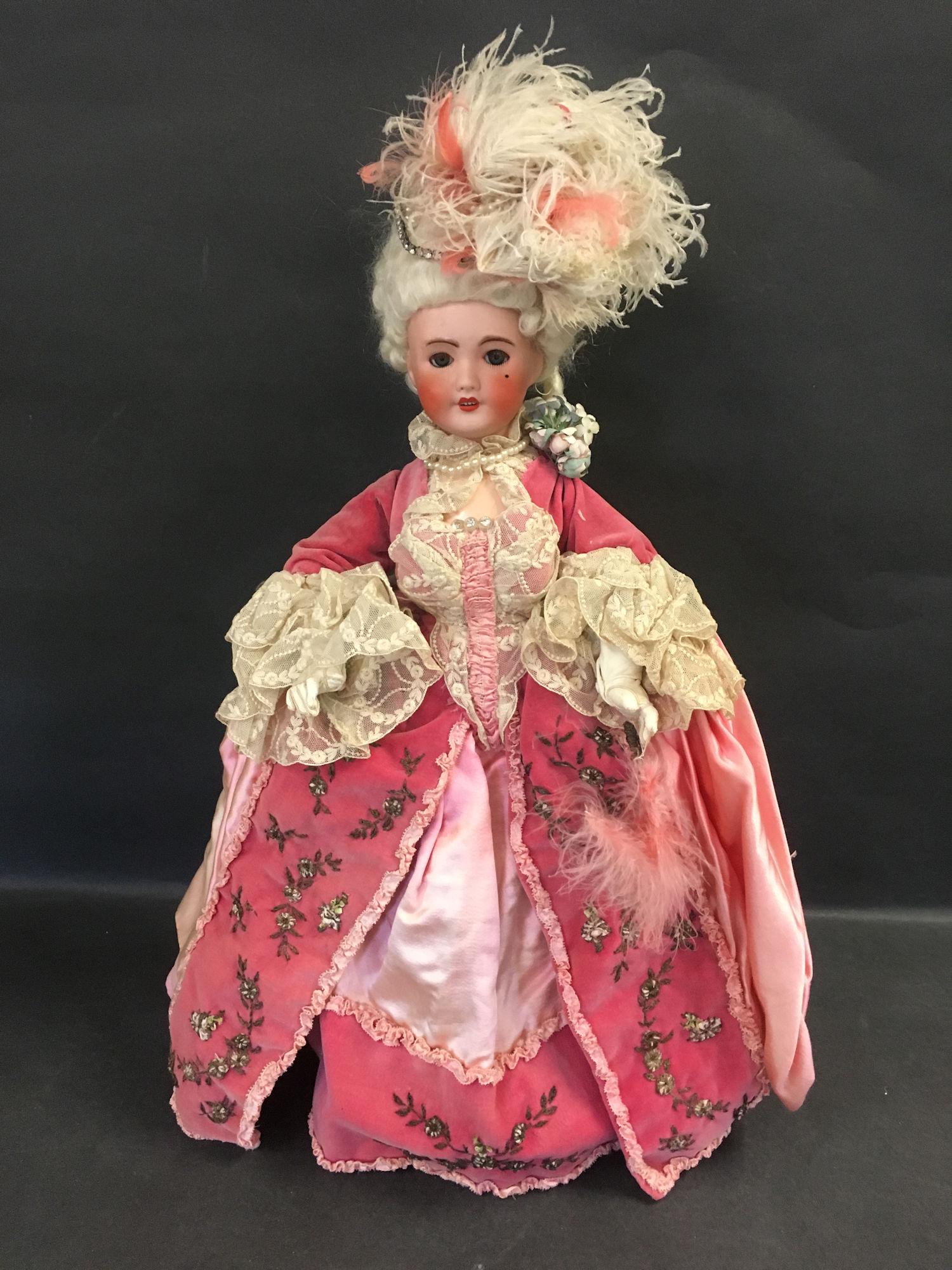19" UNIS FRANCE 301 BISQUE SOCKET HEAD LADY: 19" UNIS FRANCE 301 BISQUE SOCKET HEAD LADY DRESSED AS "MARIE ANTOINETTE". MOHAIR WIG, GLASS SLEEP EYES, OPEN MOUTH WITH TEETH, ON JOINTED COMPOSITION BODY. BEAUTIFULLY COSTUMED IN PINK SATIN AND VELV
