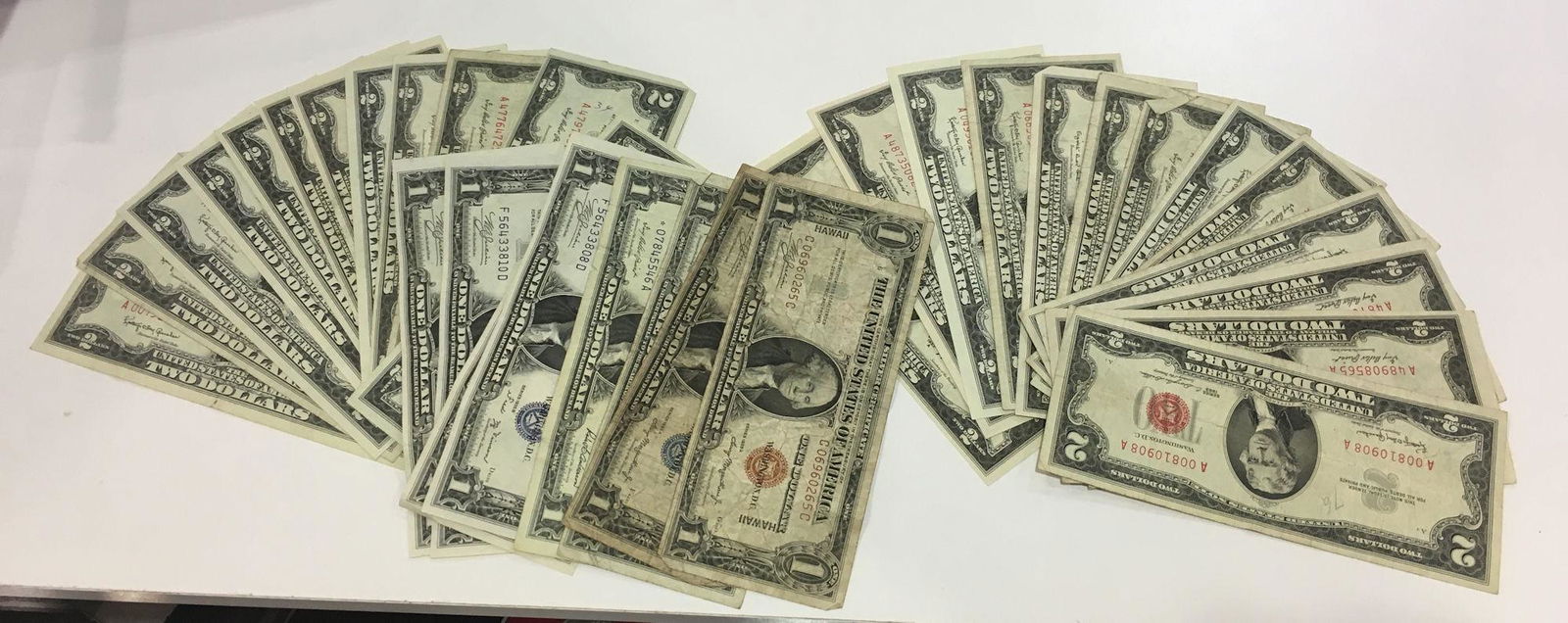 U.S. CURRENCY: U.S. CURRENCY ~ LOT INCLUDES SEVEN ONE DOLLAR BLUE SEAL NOTES INCLUDING THREE CONSECUTIVE 1935-B SERIES, ONE HAWAIIAN SEAL ONE DOLLAR BILL SERIES 1935-A, 25 TWO DOLLAR RED SEAL NOTES INCLUDING EARLY E