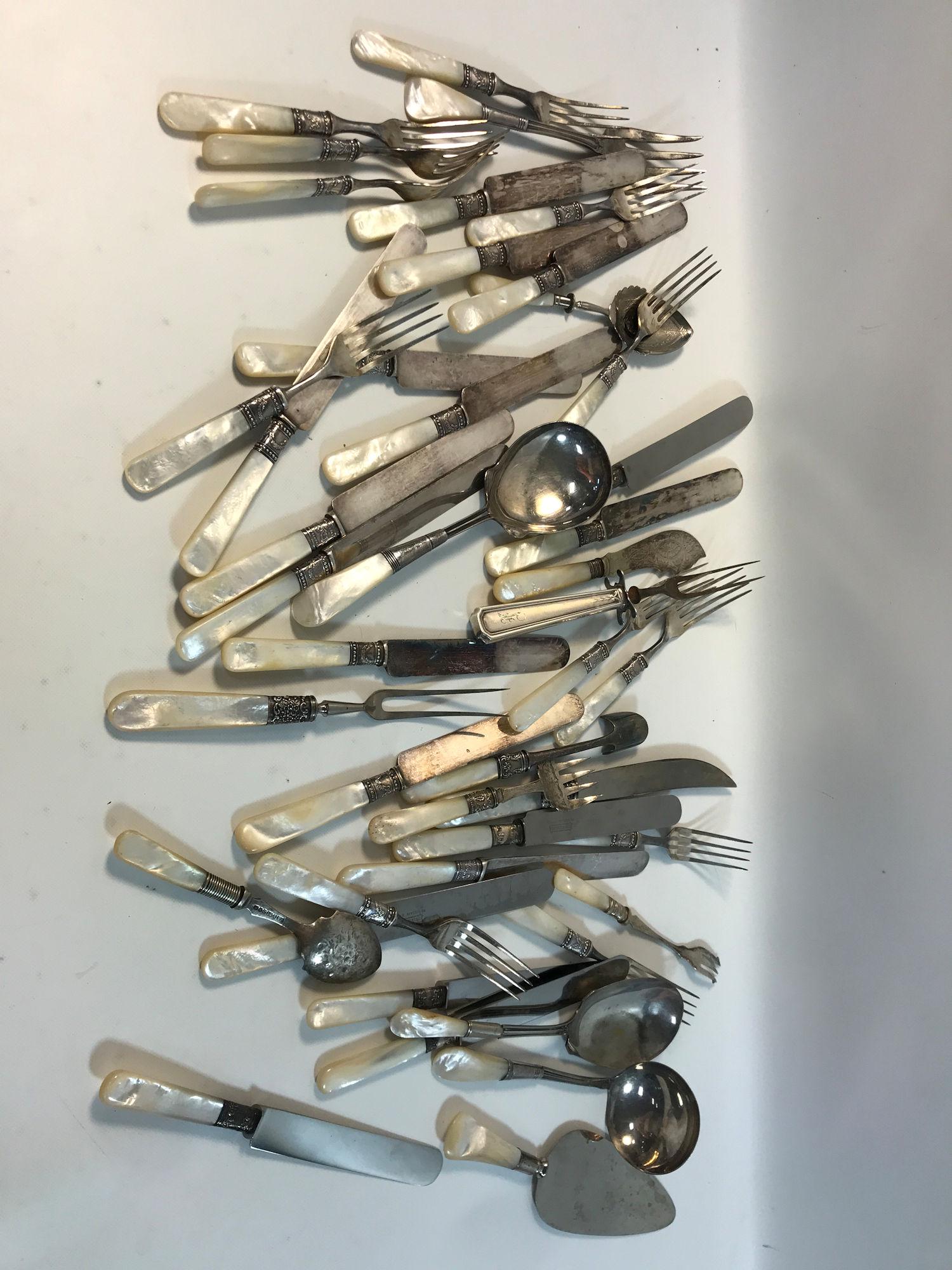VINTAGE MOTHER OF PEARL HANDLED FLATWARE: VINTAGE MOTHER OF PEARL HANDLED FLATWARE ~ STAINLESS PIECES SOME WITH STERLING ACCENTS. WHITE NACRE HANDLED FLATWARE AND SERVEWARE PCS (APPROX. TWO DOZEN) WITH STYLES FROM MERIDEN, UNIVERSAL, AJ JORDA
