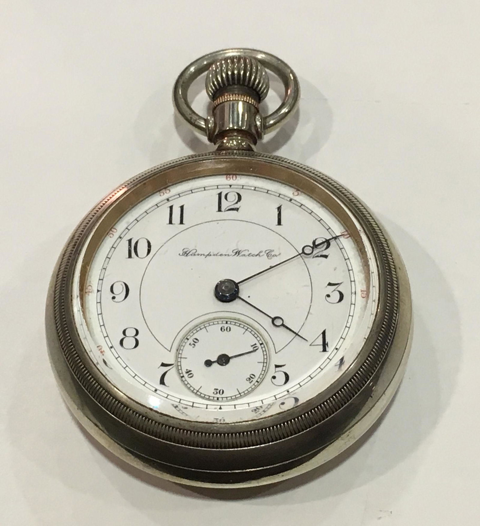 POCKET WATCH FROM HAMPDEN/DUEBER: POCKET WATCH FROM HAMPDEN/DUEBER ~ WHITE FACE W/BLACK NUMERIC INDICATORS. WINDS, SETS, AND TICKS AT TIME OF LISTING. LEVER SET. FRONT-OPEN SCREW CASE. SILVERINE CASE FROM DUEBER. MOVEMENT NUMBERED 199