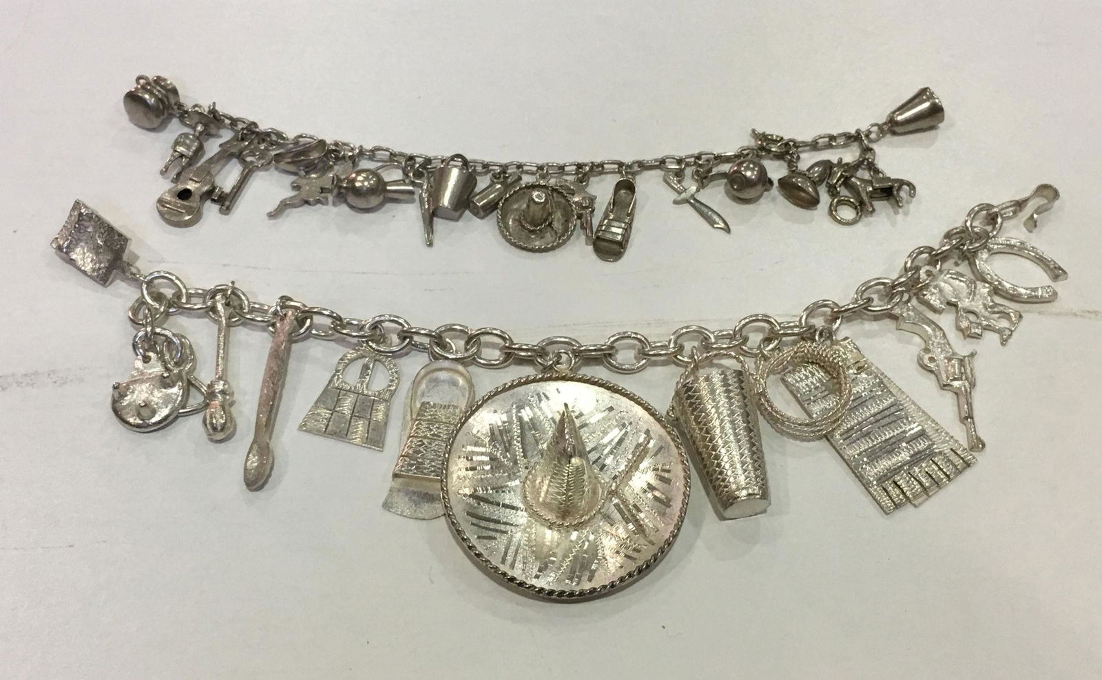 TWO STERLING STYLE CHARM BRACELETS (1 of 5)