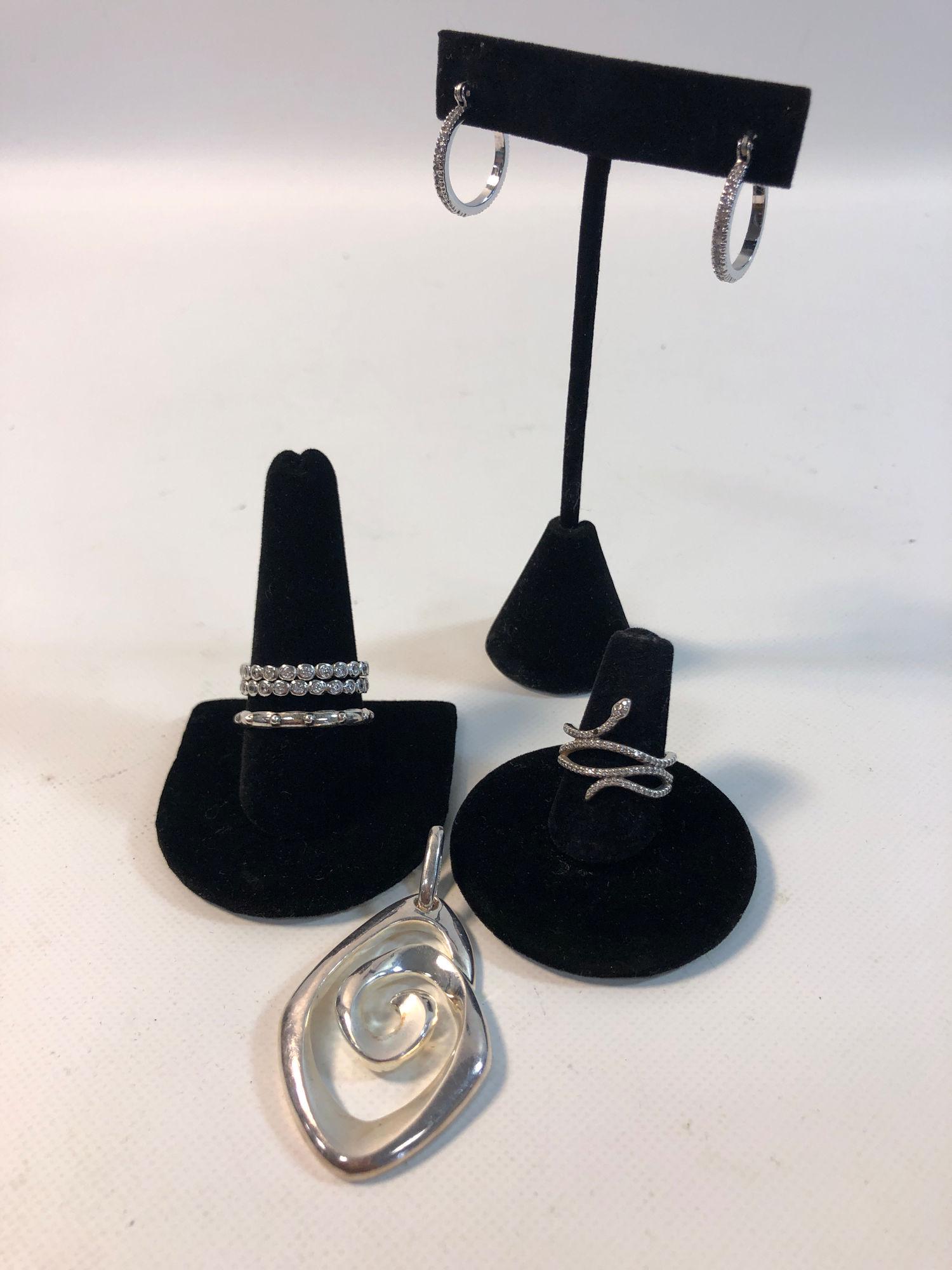 STERLING AND SILVER TONE ACCESSORIES LOT: STERLING AND SILVER TONE ACCESSORIES LOT ~ INCLUDES: 2.25" STERLING SILVER SPIRAL PENDANT (ARTIST MADE) WITH HIGH POLISH FINISH, THREE STACKABLE RINGS (STERLING) SIZES 8.75 - 11.5 (TWO WITH BEZEL SET