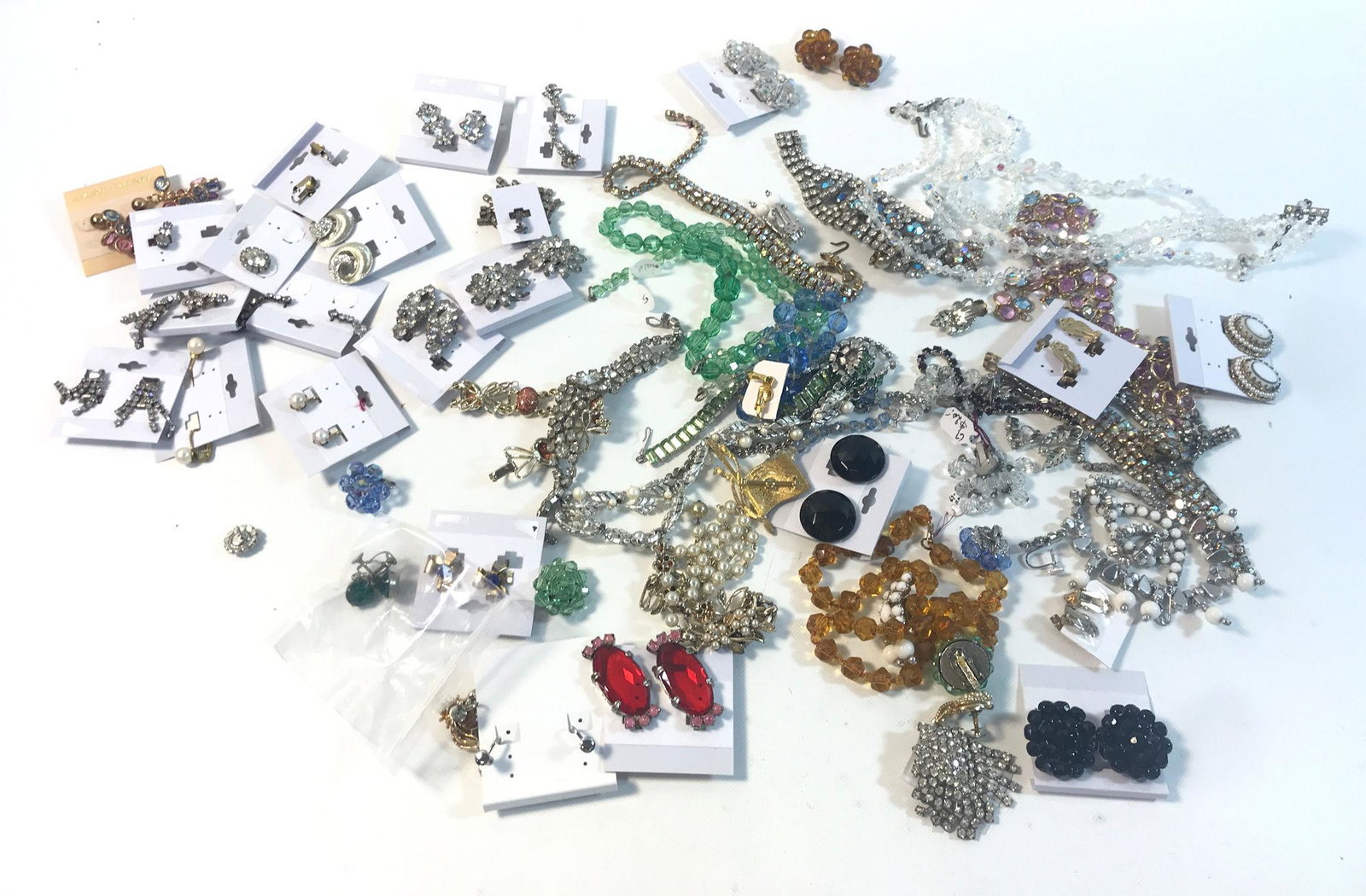 VINTAGE RHINESTONE ACCESSORIES: VINTAGE RHINESTONE ACCESSORIES ~ LOT INCLUDES DOZENS OF PRS. OF EARRINGS MOSTLY CLIP ON INCLUDING DESIGNS FROM WEST GERMANY, LISNER, JAPAN AND MORE, NECKLACES INCLUDING ADJUSTABLE CHOKER LENGTH MULTI-