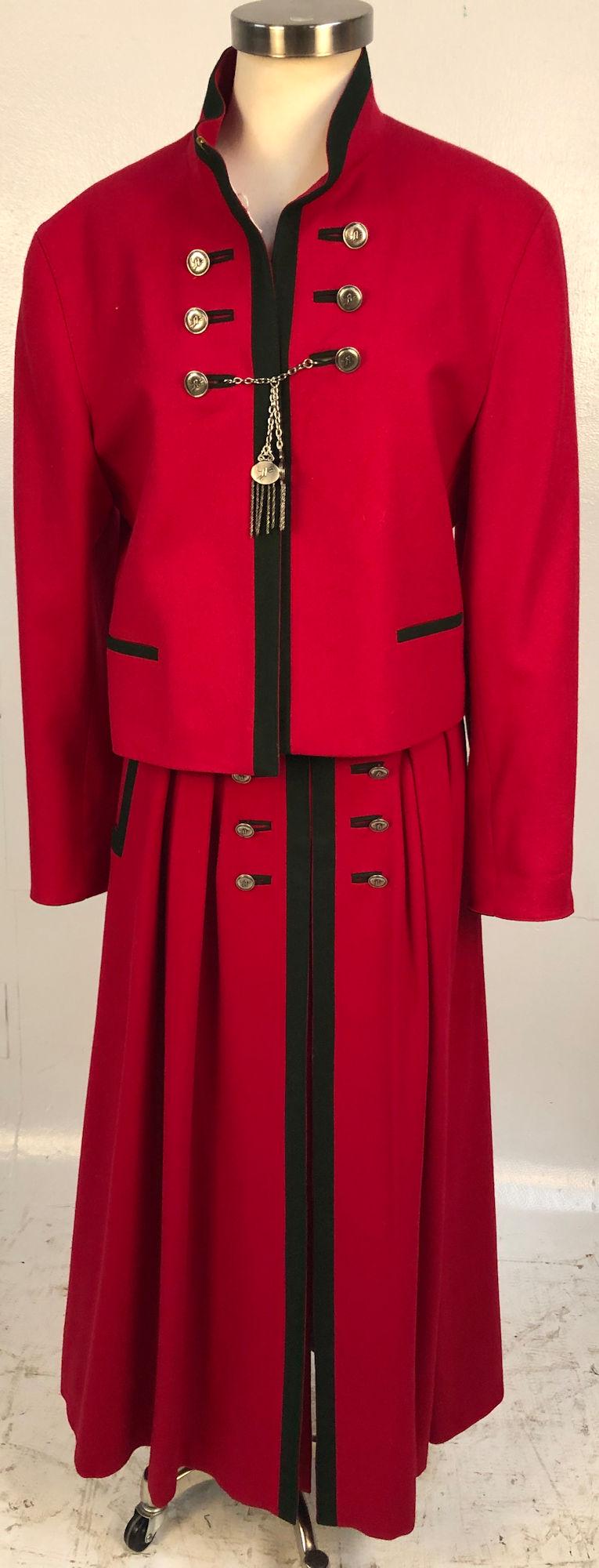 TWO PIECE LADIES BLAZER AND SKIRT FROM ADMONT: TWO PIECE LADIES BLAZER AND SKIRT FROM ADMONT ~ BLAZER SIZE 40 MADE IN WESTERN GERMANY FEATURES RED BODY WITH GREEN TRIM, BUTTON UP FRONT WITH SILVER TONE BRANDED TOGGLE CLASP ACCENT, MATCHING SKIRT S