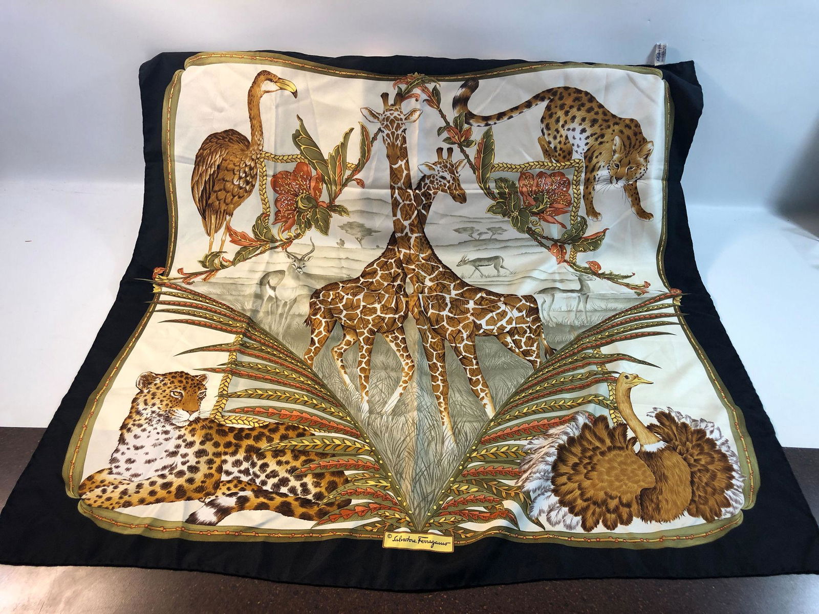 FERRAGAMO SILK SCARF: FERRAGAMO SILK SCARF ~ VINTAGE 1970'S-1980'S "TWO GIRAFFE DESIGN" BLACK BORDER, DESIGN FEATURES HIGHLY DETAILED AND COLORFUL AFRICAN SCENE W/ NATIVE ANIMALS, ITALIAN MADE, LIKE NEW CONDITION VERY GENT