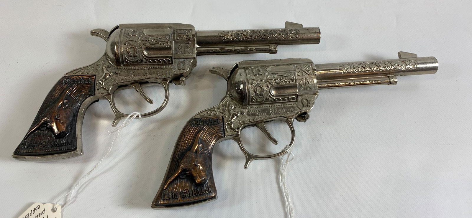 PAIR LESLIE HENRY WILD BILL HICKOK 1950's CAP GUNS WITH: PAIR LESLIE HENRY WILD BILL HICKOK 1950's CAP GUNS WITH COPPER STEER HEAD GRIPS AND POP UP CAP BOX