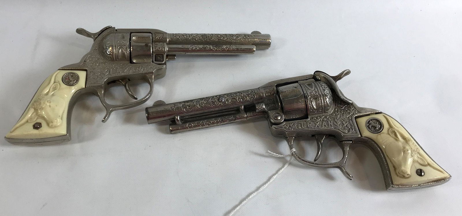 PAIR HUBLEY 1940's CAST IRON "TEXAN" CAP GUNS WITH: PAIR HUBLEY 1940's CAST IRON "TEXAN" CAP GUNS WITH WHITE STEER HEAD GRIPS