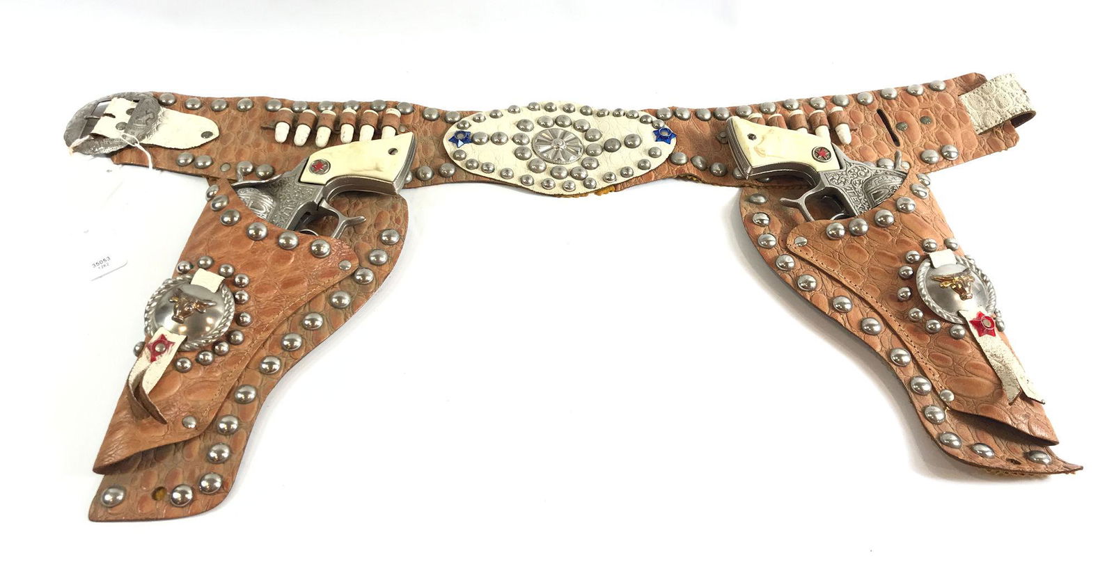 TAN LEATHER DOUBLE HOLSTER SET WITH WHITE BULLETS,: TAN LEATHER DOUBLE HOLSTER SET WITH WHITE BULLETS, SILVER STUDS AND CONCHOS WITH PAIR HUBLEY 1940's CAST IRON "TEXAN" CAP GUNS WITH WHITE STEER HEAD GRIPS