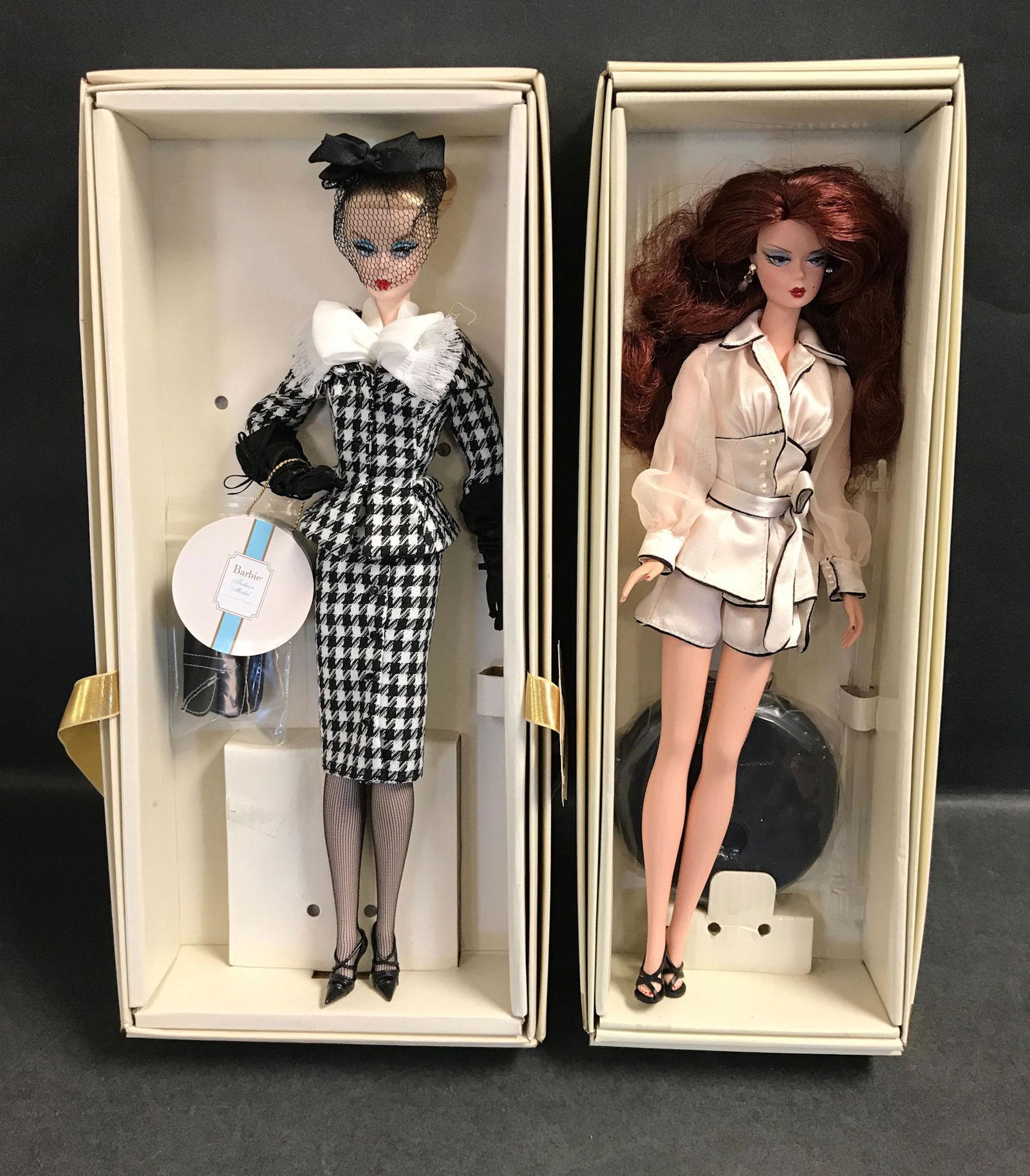 (2) SILKSTONE BARBIES INCLUDING "WALKING SUIT" AND: (2) SILKSTONE BARBIES INCLUDING "WALKING SUIT" AND "SUITE RETREAT". BOTH DOLLS HAVE BEEN REMOVED FROM THEIR BOXES AND DISPLAYED. BOXES ARE INCLUDED.