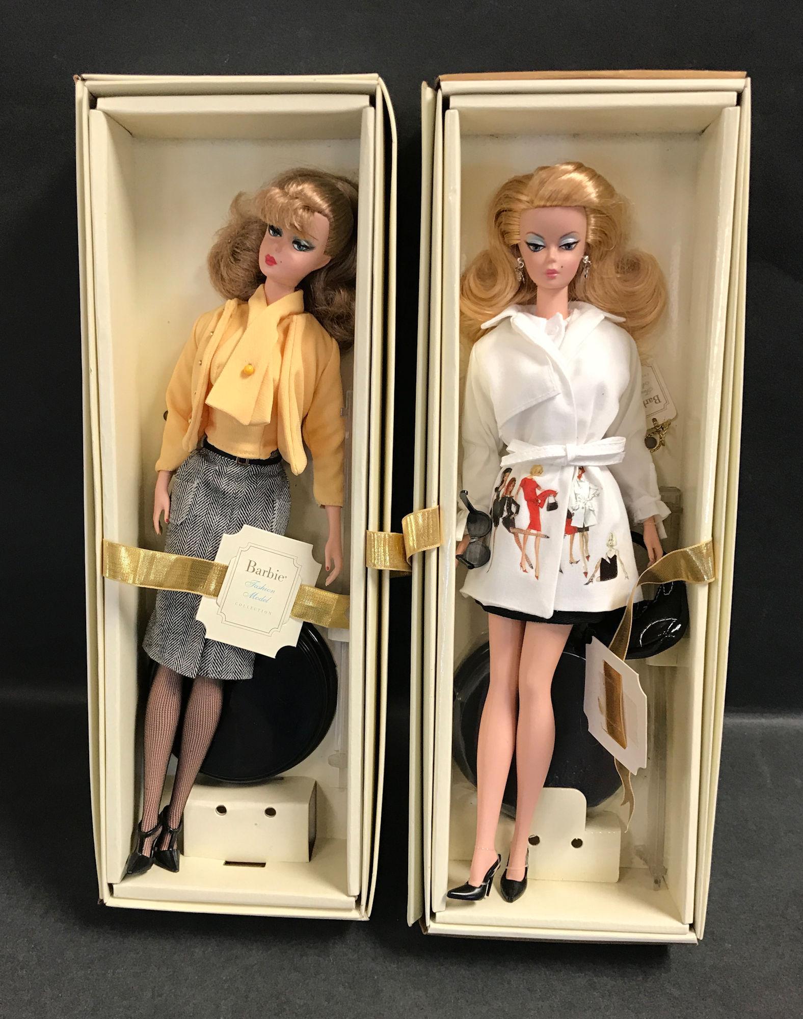 (2) SILKSTONE BARBIES INCLUDING "THE SECRETARY" AND: (2) SILKSTONE BARBIES INCLUDING "THE SECRETARY" AND "TRENCH SETTER". BOTH DOLLS HAVE BEEN REMOVED FROM THEIR BOXES AND DISPLAYED. BOXES AND DISPLAY STANDS ARE INCLUDED.