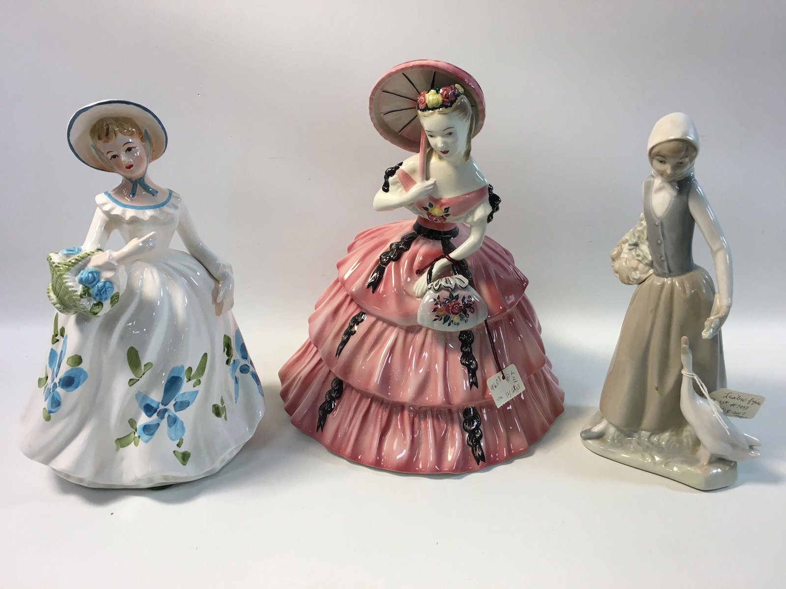 BOX LOT OF THREE MISCELLANEOUS FIGURINES INCLUDING: BOX LOT OF THREE MISCELLANEOUS FIGURINES INCLUDING NAPCOWARE VASE, LARGE GOLDSCHEIDER FIGURINE OF LADY IN PINK DRESS WITH PARASOL AND ONE LEGALNO FIGURINE OF LADY WITH GOOSE