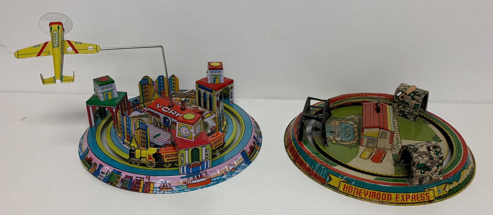 BOX LOT WITH TWO (2) TIN WIND-UP TOYS, "HONEYMOON: BOX LOT WITH TWO (2) TIN WIND-UP TOYS, "HONEYMOON EXPRESS" AND PLANE.