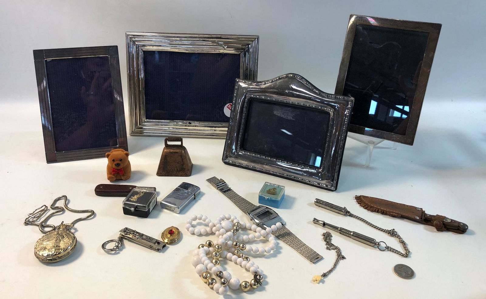 ASSORTED FRAMES AND ACCESSORIES LOT: ASSORTED FRAMES AND ACCESSORIES LOT ~ LOT INCLUDES: FOUR ASSORTED SILVER TONE AND SILVER PLATE METAL/GLASS PICTURE FRAMES, A MODERN POCKET WATCH WITH HIGH RELIEF CASE FT. STATUE OF LIBERTY MOTIF, SILV