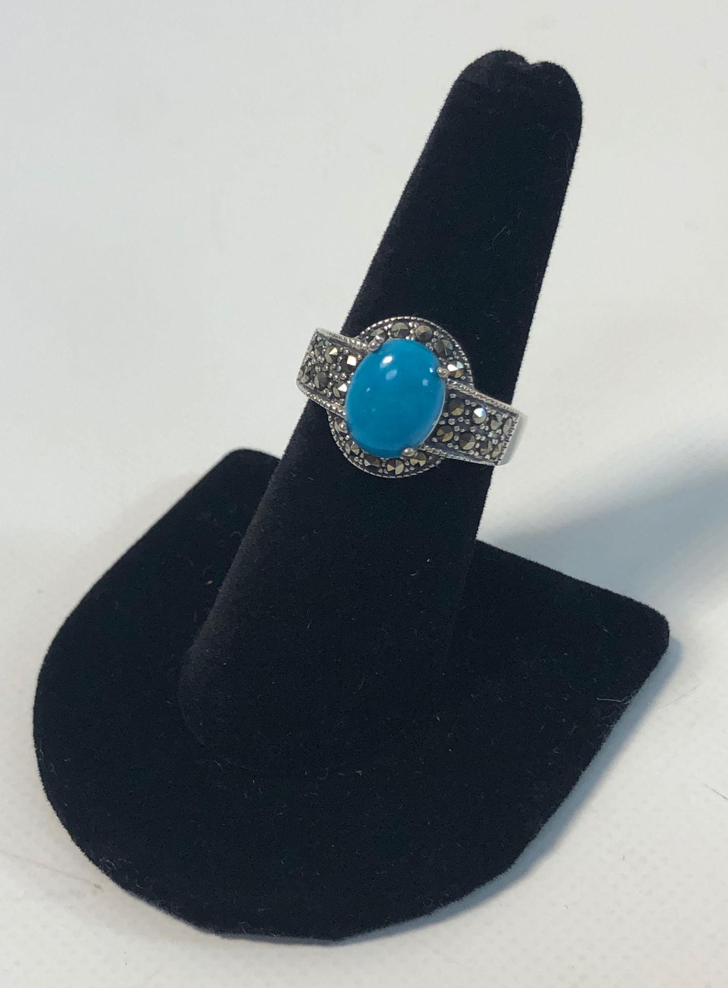 SILVER AND STONE FASHION RING: SILVER AND STONE FASHION RING ~ STERLING SILVER (STAMPED AND TESTED 925). THAILAND MADE. SOUTHWESTERN STYLE. SIGNED "FD". 0.2 TROY OUNCES TW. BLUE TURQUOISE CENTER STONE CABOCHON WITH MARCASITE/PYRITE