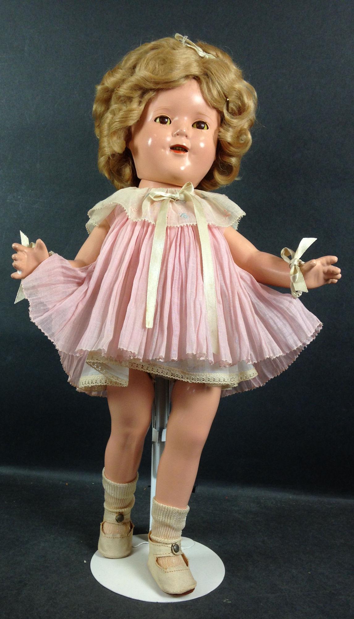 17" IDEAL COMPOSITION SHIRLEY TEMPLE DOLL. MOHAIR WIG: 17" IDEAL COMPOSITION SHIRLEY TEMPLE DOLL. MOHAIR WIG IN ORIGINAL SET, SLEEP EYES, OPEN MOUTH WITH TEETH, ON FIVE PIECE COMPOSITION BODY. DOLL IS DRESSED IN ORIGINAL TAGGED (NRA) "BABY TAKE A BOW" DRE