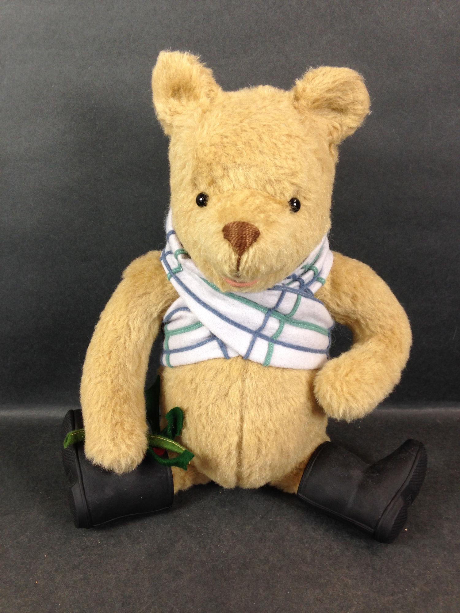 13" R. JOHN WRIGHT "HOLIDAY WINNIE-THE-POOH". COTTON: 13" R. JOHN WRIGHT "HOLIDAY WINNIE-THE-POOH". COTTON PLUSH BEAR JOINTED AT NECK, SHOULDERS AND HIPS, SHOE BUTTON EYES, STITCHED NOSE, PAINTED OPEN MOUTH. LIMITED EDITION #0007/1000.