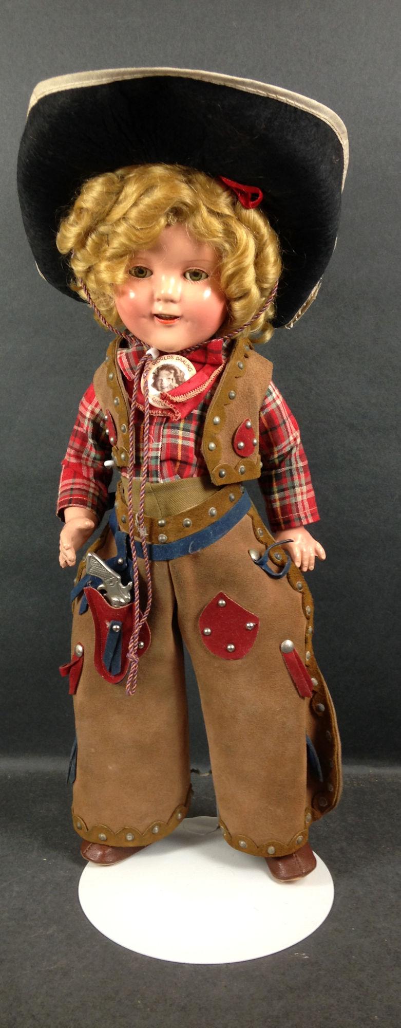 17" IDEAL COMPOSITION SHIRLEY TEMPLE "COWBOY DOLL".: 17" IDEAL COMPOSITION SHIRLEY TEMPLE "COWBOY DOLL". MOHAIR WIG IN ORIGINAL SET, SLEEP EYES, OPEN MOUTH WITH TEETH, ON FIVE PIECE COMPOSITION BODY. DOLL IS DRESSED IN TEXAS RANGER COSTUME CELEBRATING T