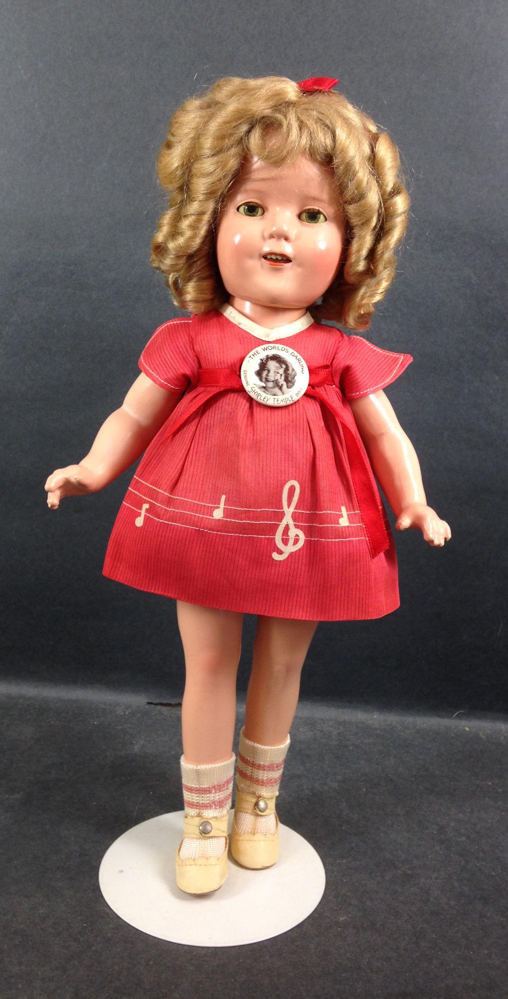 15" IDEAL COMPOSITION SHIRLEY TEMPLE DOLL. MOHAIR WIG: 15" IDEAL COMPOSITION SHIRLEY TEMPLE DOLL. MOHAIR WIG IN ORIGINAL SET, SLEEP EYES, OPEN MOUTH WITH TEETH, ON FIVE PIECE COMPOSITION BODY. DOLL WEARS TAGGED NRA DIMITY MUSIC NOTE DRESS FROM "OUR LITTLE