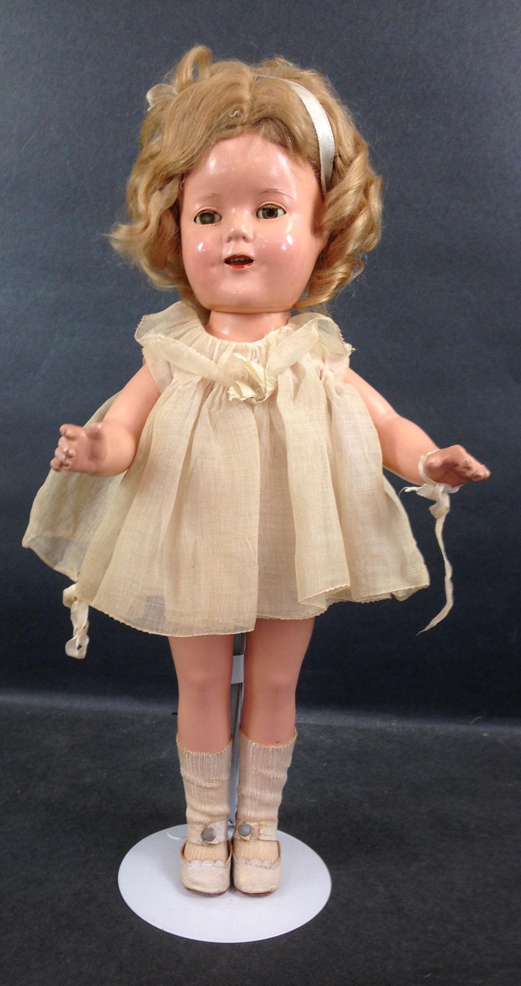 16" IDEAL COMPOSITION SHIRLEY TEMPLE DOLL. ORIGINAL: 16" IDEAL COMPOSITION SHIRLEY TEMPLE DOLL. ORIGINAL MOHAIR WIG, SLEEP EYES, OPEN MOUTH WITH TEETH, ON FIVE PIECE COMPOSITION BODY. DOLL WEARS TAGGED NRA DRESS, UNDERCLOTHING, CENTER SNAP SHOES AND SOC