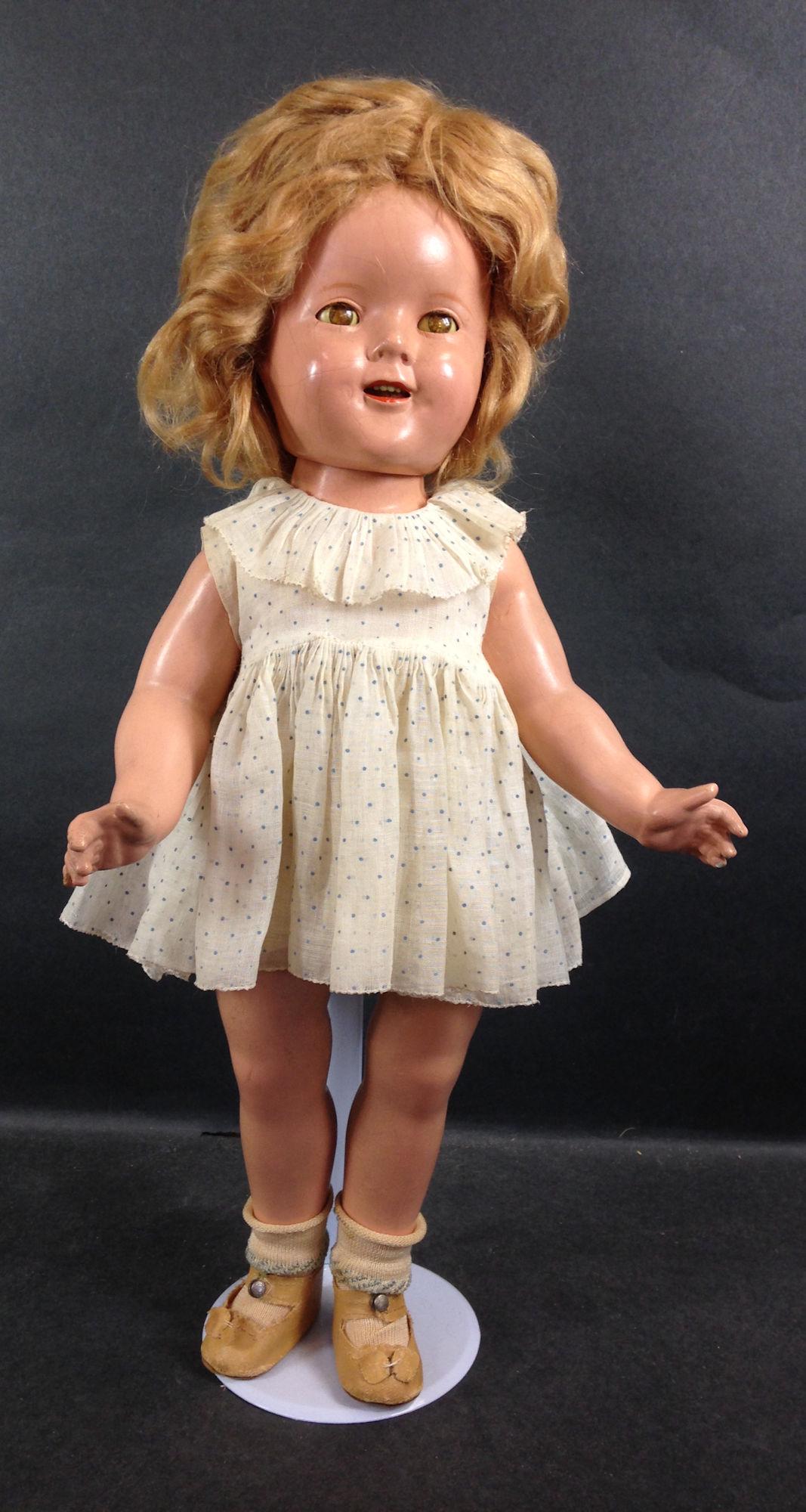 18" IDEAL COMPOSITION SHIRLEY TEMPLE DOLL. ORIGINAL: 18" IDEAL COMPOSITION SHIRLEY TEMPLE DOLL. ORIGINAL MOHAIR WIG, SLEEP EYES, OPEN MOUTH WITH TEETH, ON FIVE PIECE COMPOSITION BODY. DOLL WEARS TAGGED NRA BLUE AND WHITE POLKA DOT "DANCING DRESS", UNDER