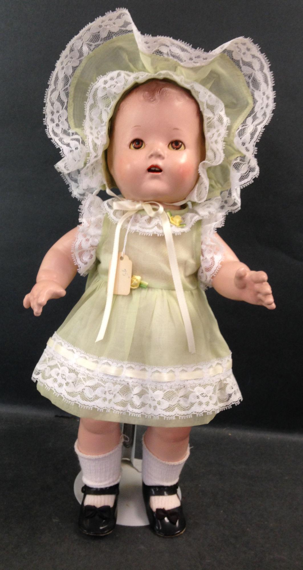 16½" UNMARKED COMPOSITION QUINT-TYPE BABY.: 16½" UNMARKED COMPOSITION QUINT-TYPE BABY. MOLDED AND PAINTED HAIR, SLEEP EYES, OPEN MOUTH WITH TEETH, ON FIVE PIECE COMPOSITION BENT LIMB BODY. DOLL IS DRESSED IN GREEN ORGANDY WITH MATCHING B