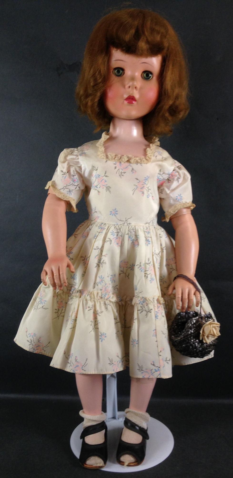 30" UNMARKED VINYL WALKER. ROOTED SYNTHETIC HAIR, SLEEP: 30" UNMARKED VINYL WALKER. ROOTED SYNTHETIC HAIR, SLEEP EYES, ON HARD PLASTIC BODY WITH VINYL ARMS JOINTED AT ELBOWS, HARD PLASTIC LEGS JOINTED AT KNEES. DOLL WEARS LIKELY ORIGINAL DRESS AND UNDERCLOT