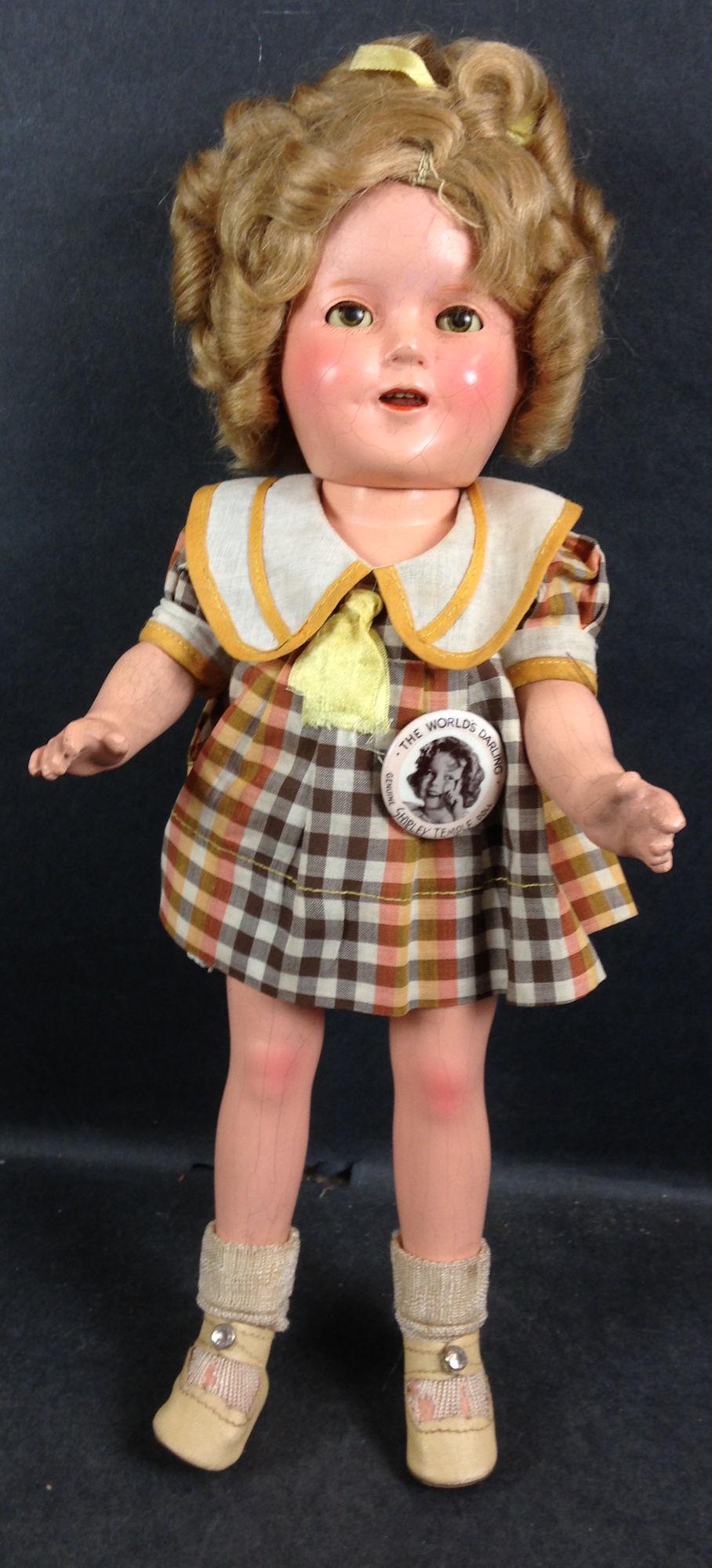 13" IDEAL COMPOSITION SHIRLEY TEMPLE DOLL. MOHAIR WIG: 13" IDEAL COMPOSITION SHIRLEY TEMPLE DOLL. MOHAIR WIG IN ORIGINAL SET, SLEEP EYES, OPEN MOUTH WITH TEETH, ON FIVE PIECE COMPOSITION BODY. DOLL IS DRESSED IN ORIGINAL TAGGED DRESS FROM "BRIGHT EYES", U