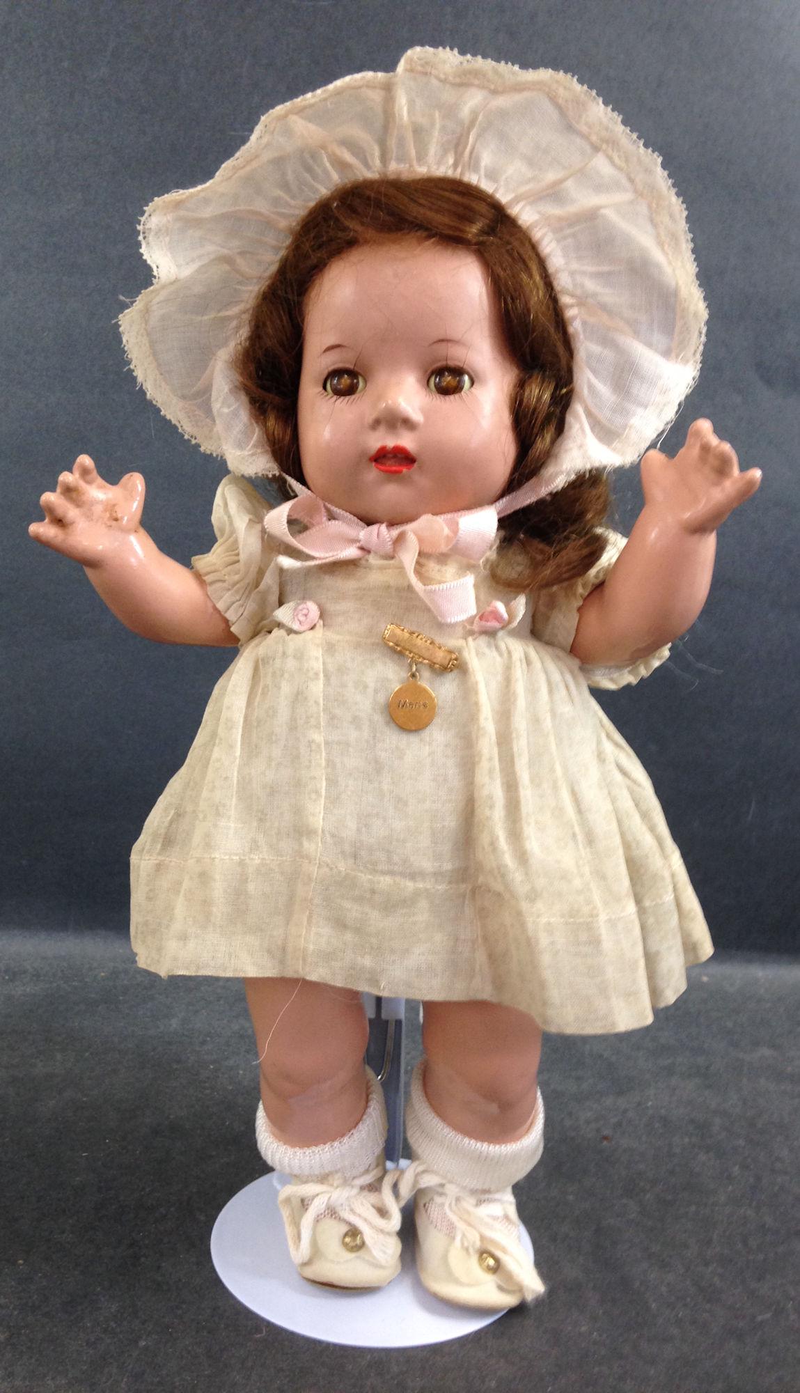 11" MADAME ALEXANDER COMPOSITION DIONNE QUINT "MARIE".: 11" MADAME ALEXANDER COMPOSITION DIONNE QUINT "MARIE". HUMAN HAIR WIG, SLEEP EYES, OPEN MOUTH WITH UPPER TEETH, ON FIVE PIECE COMPOSITION BENT LIMB BODY. DOLL WEARS TAGGED BLUE ORGANDY DRESS WITH PINK