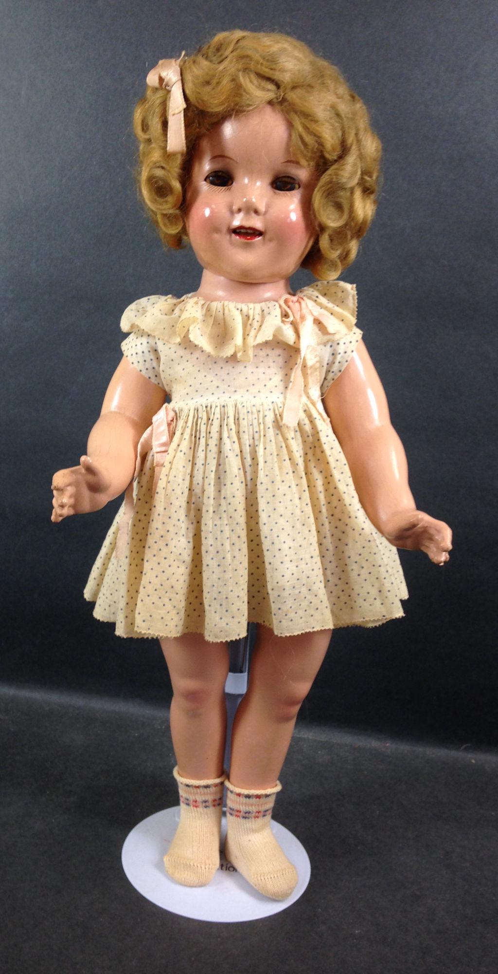 18" IDEAL COMPOSITION SHIRLEY TEMPLE DOLL. MOHAIR WIG: 18" IDEAL COMPOSITION SHIRLEY TEMPLE DOLL. MOHAIR WIG IN ORIGINAL SET, SLEEP EYES, OPEN MOUTH WITH TEETH, ON FIVE PIECE COMPOSITION BODY. DOLL WEARS UNTAGGED DRESS, UNDERCLOTHING AND SOCKS.