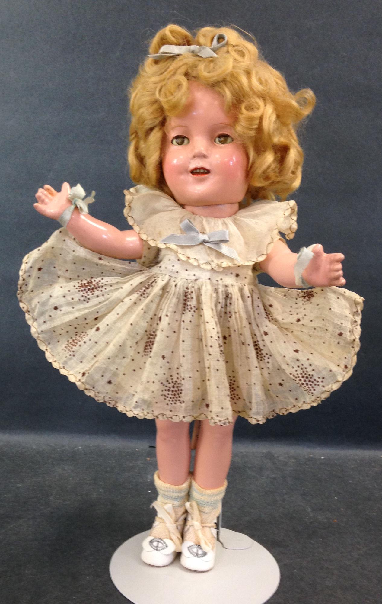13" IDEAL COMPOSITION SHIRLEY TEMPLE DOLL. MOHAIR WIG,: 13" IDEAL COMPOSITION SHIRLEY TEMPLE DOLL. MOHAIR WIG, SLEEP EYES, OPEN MOUTH WITH TEETH, ON FIVE PIECE COMPOSITION BODY. DOLL WEARS DRESS FROM "CURLY TOP" (MISSING TAG), UNDERCLOTHING AND SOCKS. SHOE