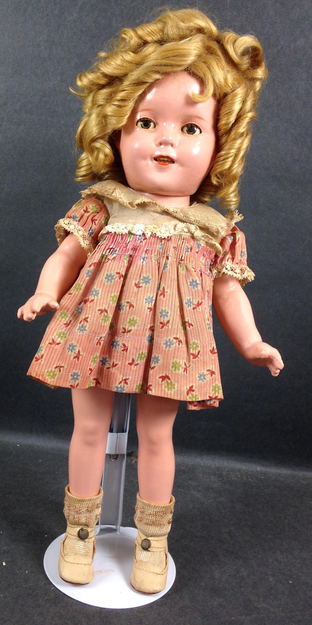 13" IDEAL COMPOSITION SHIRLEY TEMPLE DOLL. MOHAIR WIG,: 13" IDEAL COMPOSITION SHIRLEY TEMPLE DOLL. MOHAIR WIG, SLEEP EYES, OPEN MOUTH WITH TEETH, ON FIVE PIECE COMPOSITION BODY. DOLL IS DRESSED IN ORIGINAL FLORAL PRINT DRESS, UNDERCLOTHING, CENTER SNAP SHO