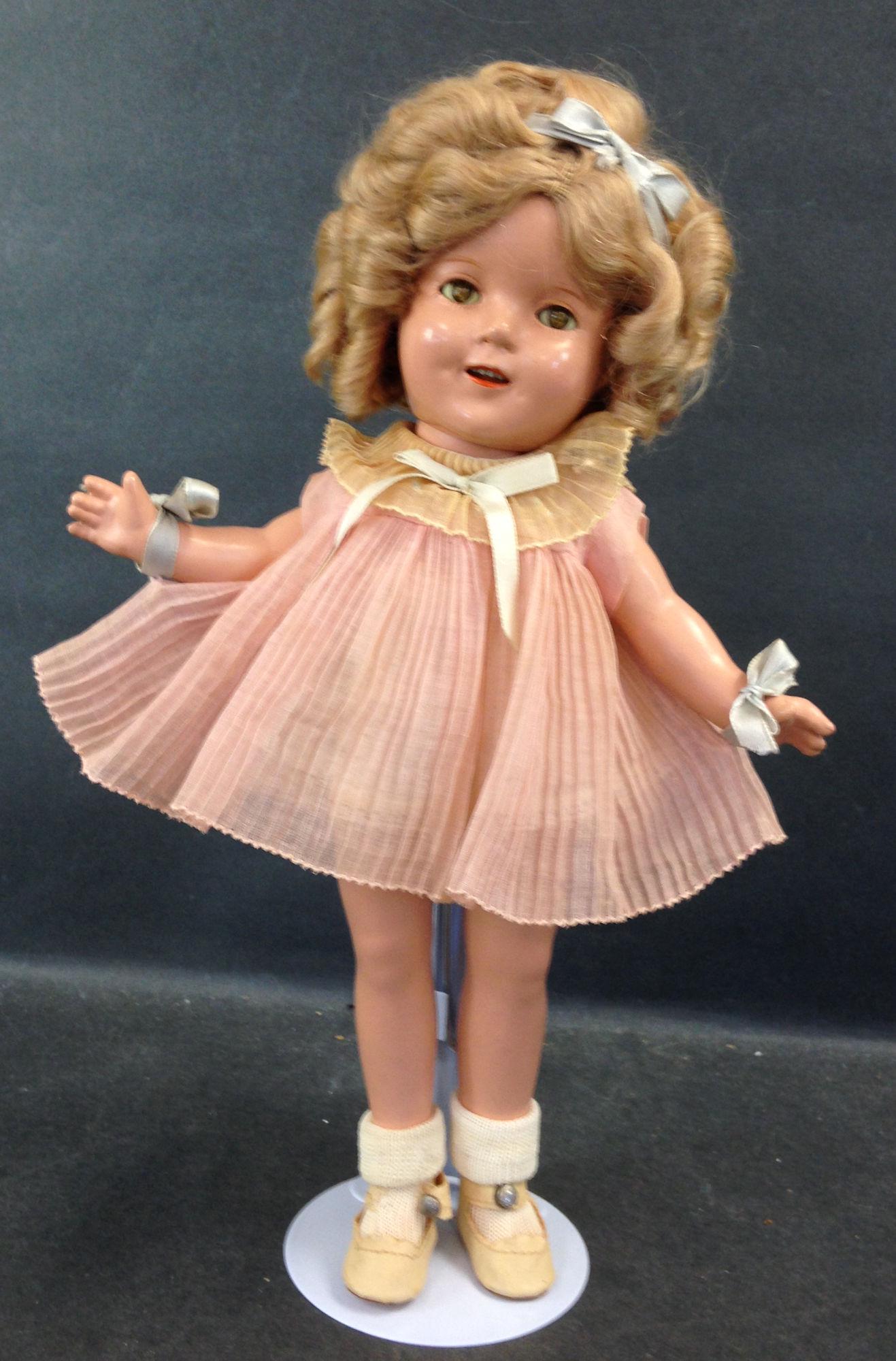 13" IDEAL COMPOSITION SHIRLEY TEMPLE DOLL. MOHAIR WIG: 13" IDEAL COMPOSITION SHIRLEY TEMPLE DOLL. MOHAIR WIG IN ORIGINAL SET, SLEEP EYES, OPEN MOUTH WITH TEETH, ON FIVE PIECE COMPOSITION BODY. DOLL WEARS PLEATED PINK DANCING DRESS, UNDERCLOTHING, CENTER S