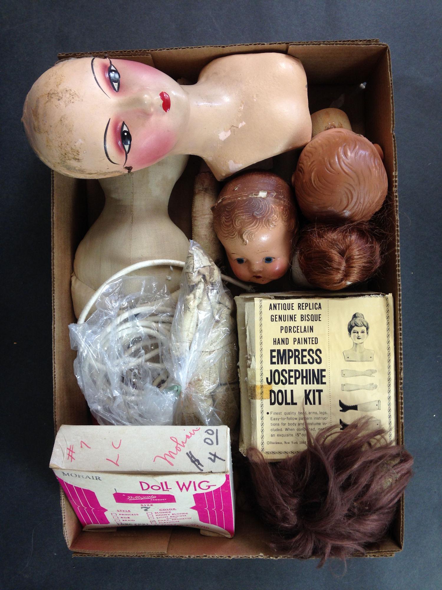 LOT OF DOLL PARTS INCLUDING (2) WIGS, DOLL HEADS, CLOTH (1 of 1)