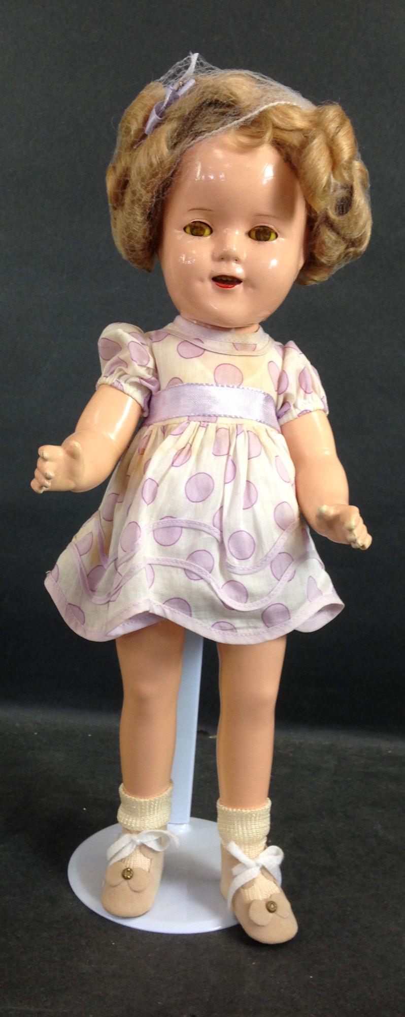 16" IDEAL COMPOSITION SHIRLEY TEMPLE DOLL. MOHAIR WIG: 16" IDEAL COMPOSITION SHIRLEY TEMPLE DOLL. MOHAIR WIG (RESET), SLEEP EYES, OPEN MOUTH WITH TEETH, ON FIVE PIECE COMPOSITION BODY. DOLL IS WEARING ORIGINAL UNTAGGED DRESS AND UNDERCLOTHING, REPLACED SH