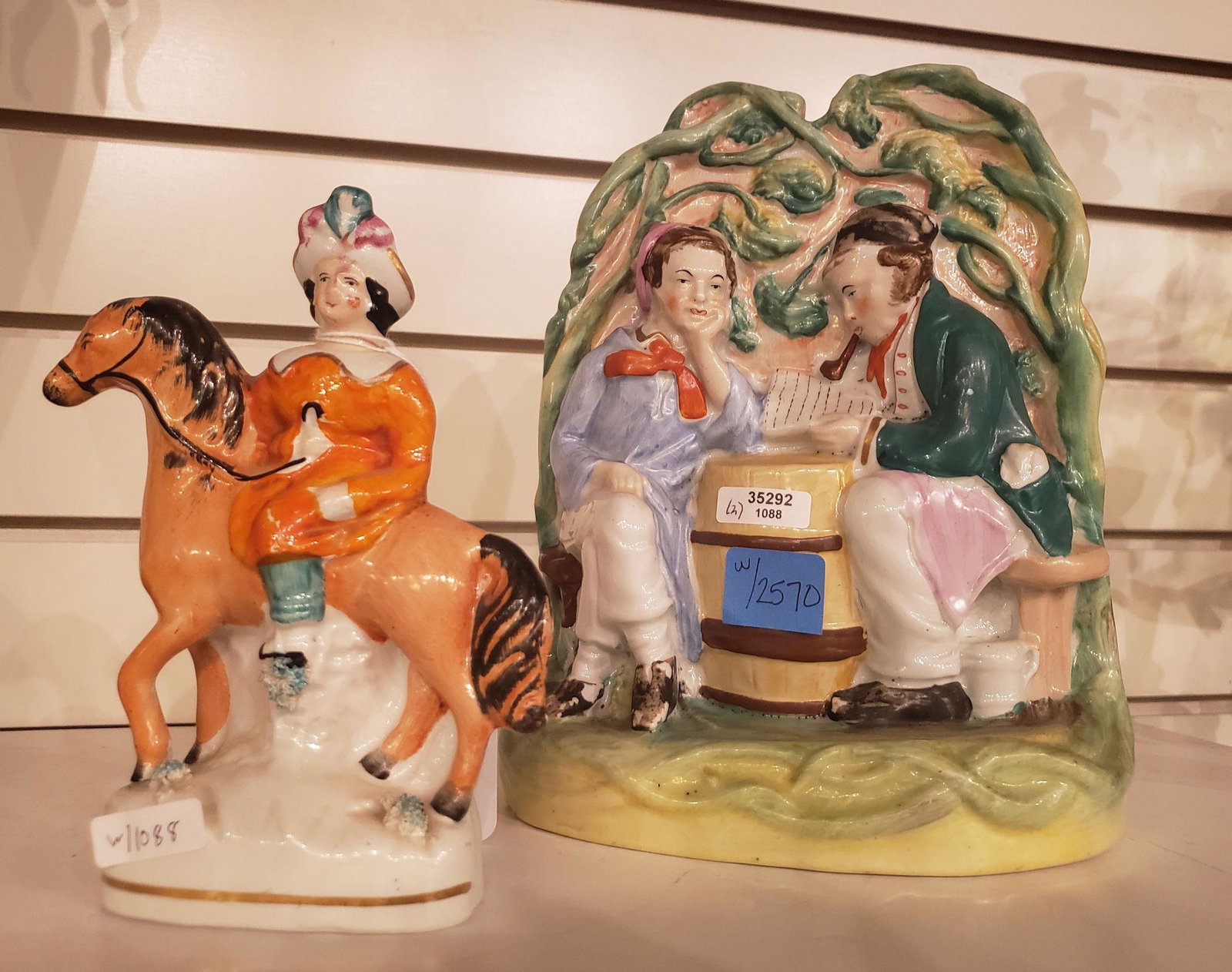 (2) STAFFORDSHIRE FIGURINES- 2 MEN ON STOOLS AND LADY (1 of 2)