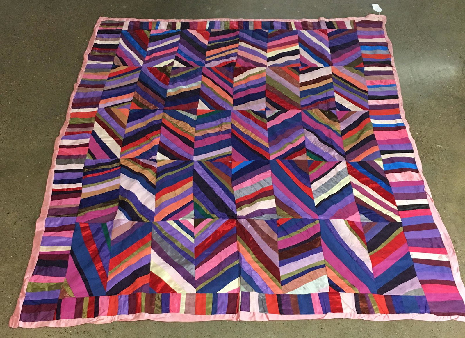 MULTI COLORED SATIN QUILT, MEASURES 62" X 74": MULTI COLORED SATIN QUILT, MEASURES 62" X 74"