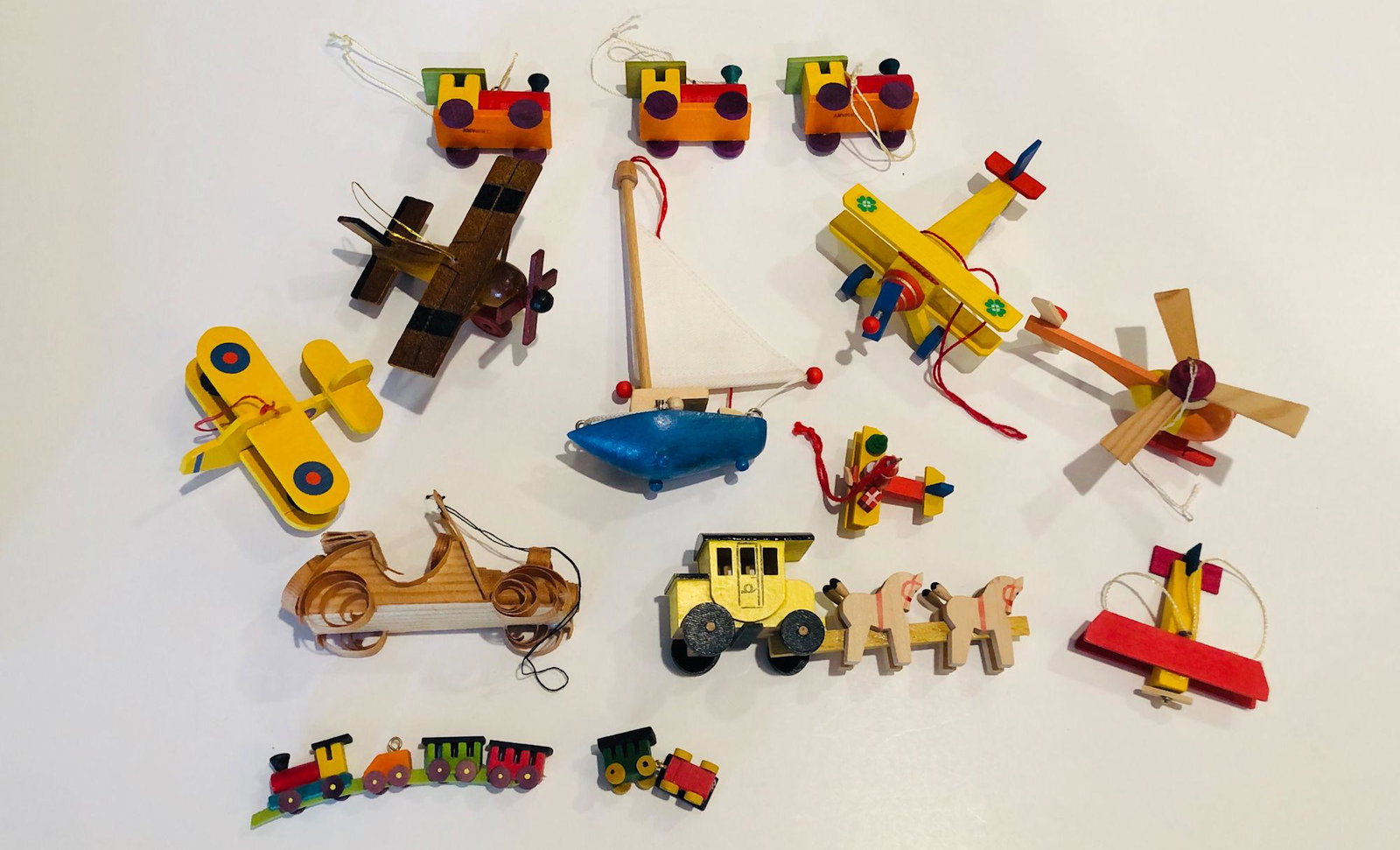 BOX LOT CHRISTMAS INCLUDING WOODEN TRANSPORTATION: BOX LOT CHRISTMAS INCLUDING WOODEN TRANSPORTATION ORNAMENTS SOME MARKED GERMANY. SAILBOAT IS APPROX 5.25" TALL