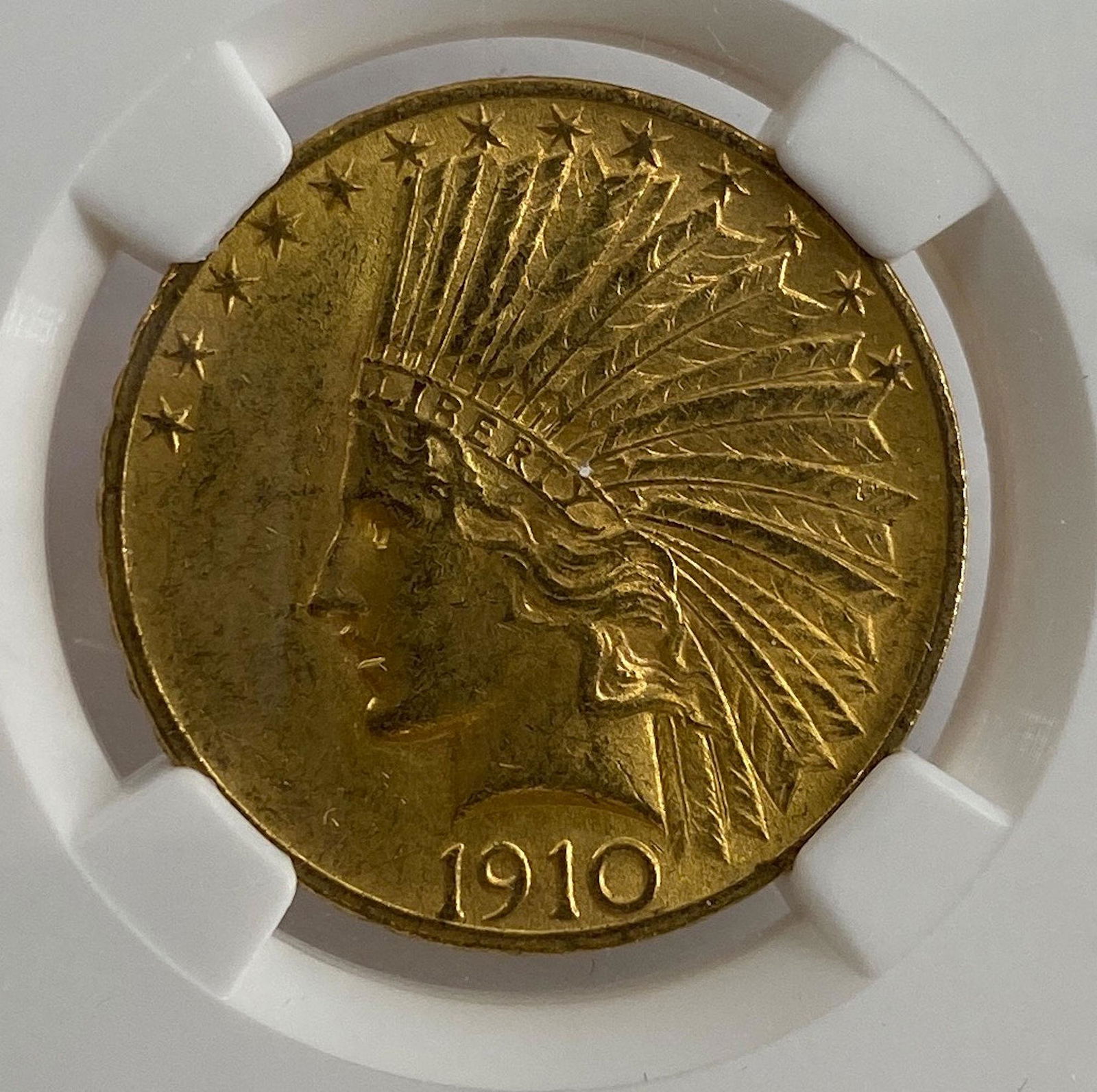 1910 U.S. $10.00 INDIAN HEAD GOLD EAGLE: 1910 U.S. $10.00 INDIAN HEAD GOLD EAGLE ~ NO MINT MARK, IN SLAB, NGC GRADED MS61, NUMBERED 3446954-008, 90% FINE GOLD, APPROX. 16.72 GRAMS TW. DESIGNED BY AUGUSTUS SAINT GAUDENS.
