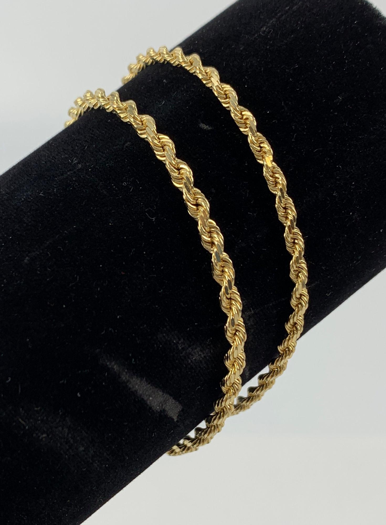 TWO 14KT GOLD BRACELETS: TWO 14KT GOLD BRACELETS ~ TWO 7" SPIRAL CHAIN BRACELETS. SLIDE CLASPS. 14KT YELLOW GOLD (STAMPED AND TESTED). UNSIGNED. POLISHED FINISHES. 10.8 GRAMS TW.