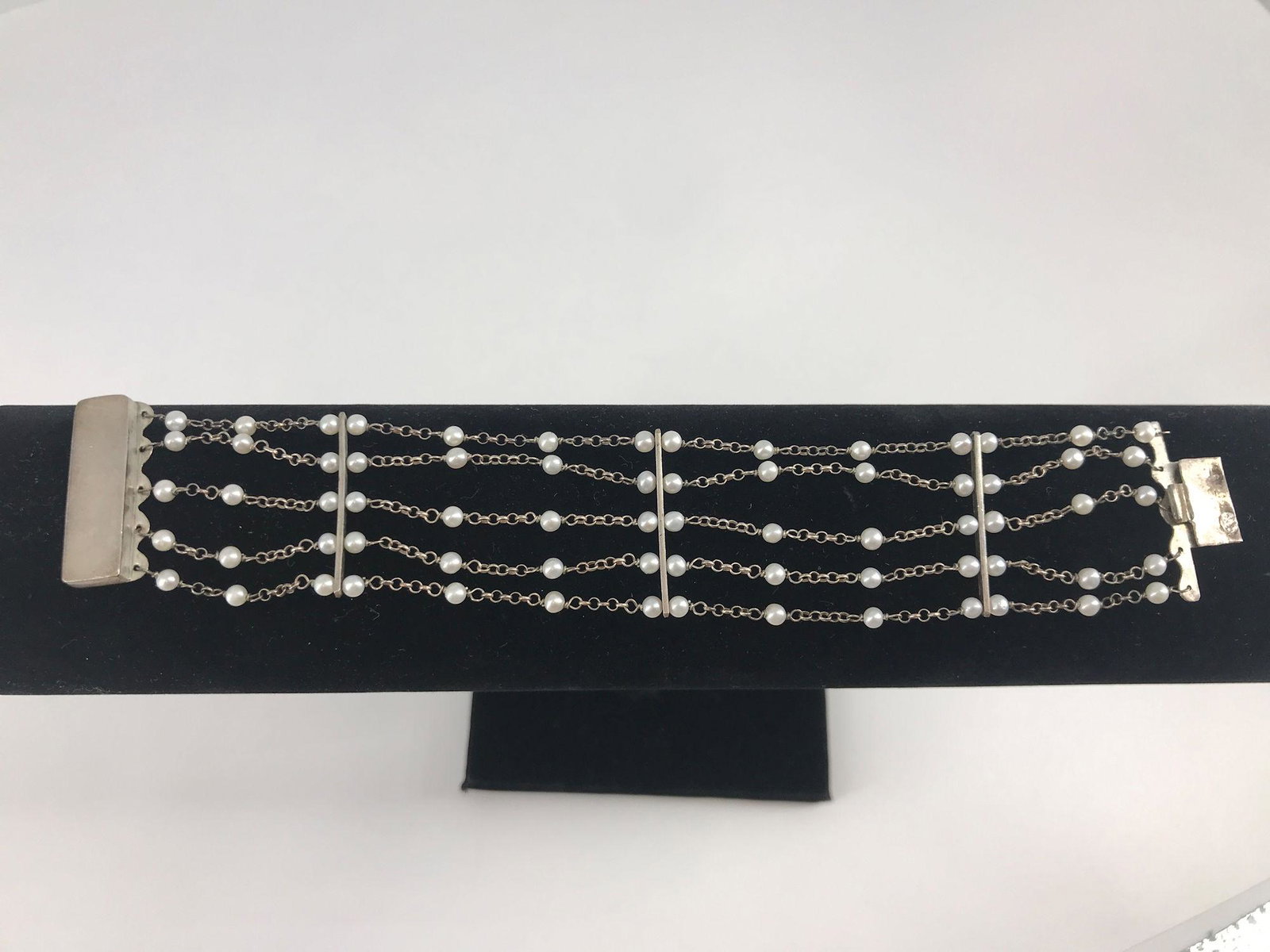 STERLING SILVER AND SEED PEARL BRACELET: STERLING SILVER AND SEED PEARL BRACELET ~ APPROX 7" IN LENGTH WITH FIVE STERLING CHAINS WITH WHITE SEED PEARL ACCENTS, BOX CLASP CLOSURE, STAMPED AND TESTED WITH THREE STERLING BAR LINK CONNECTORS (0.