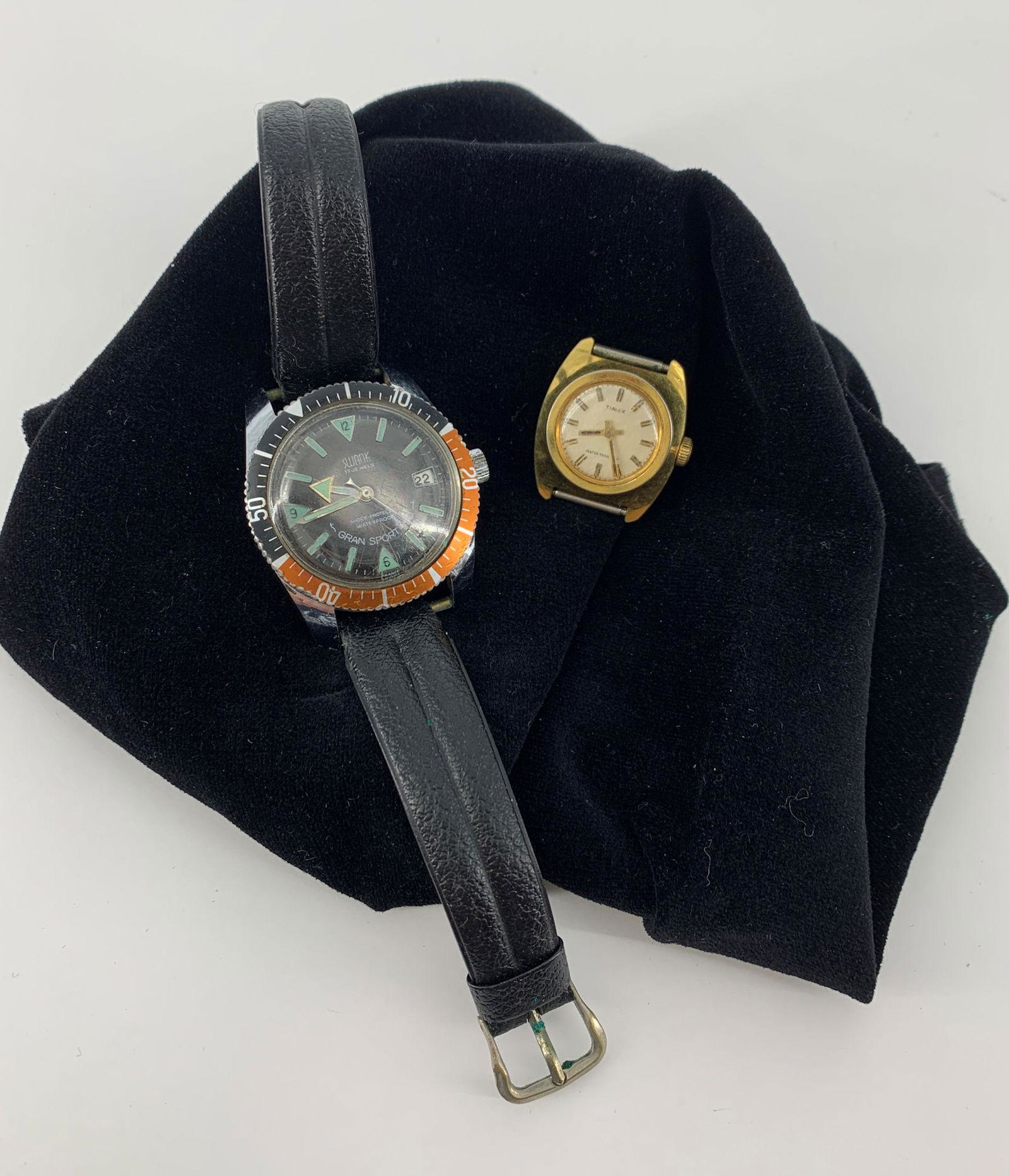TWO WATCHES: TWO WATCHES ~ GRAND SPORT WATERPROOF WRIST WATCH FROM SWANK, 17 JEWEL MOVEMENT, SHOCK PROTECTED AND WATERPROOF, ON BLACK BAND, AND ONE 1.125" X 1" GOLD TONE WATCH FACE FROM TIMEX